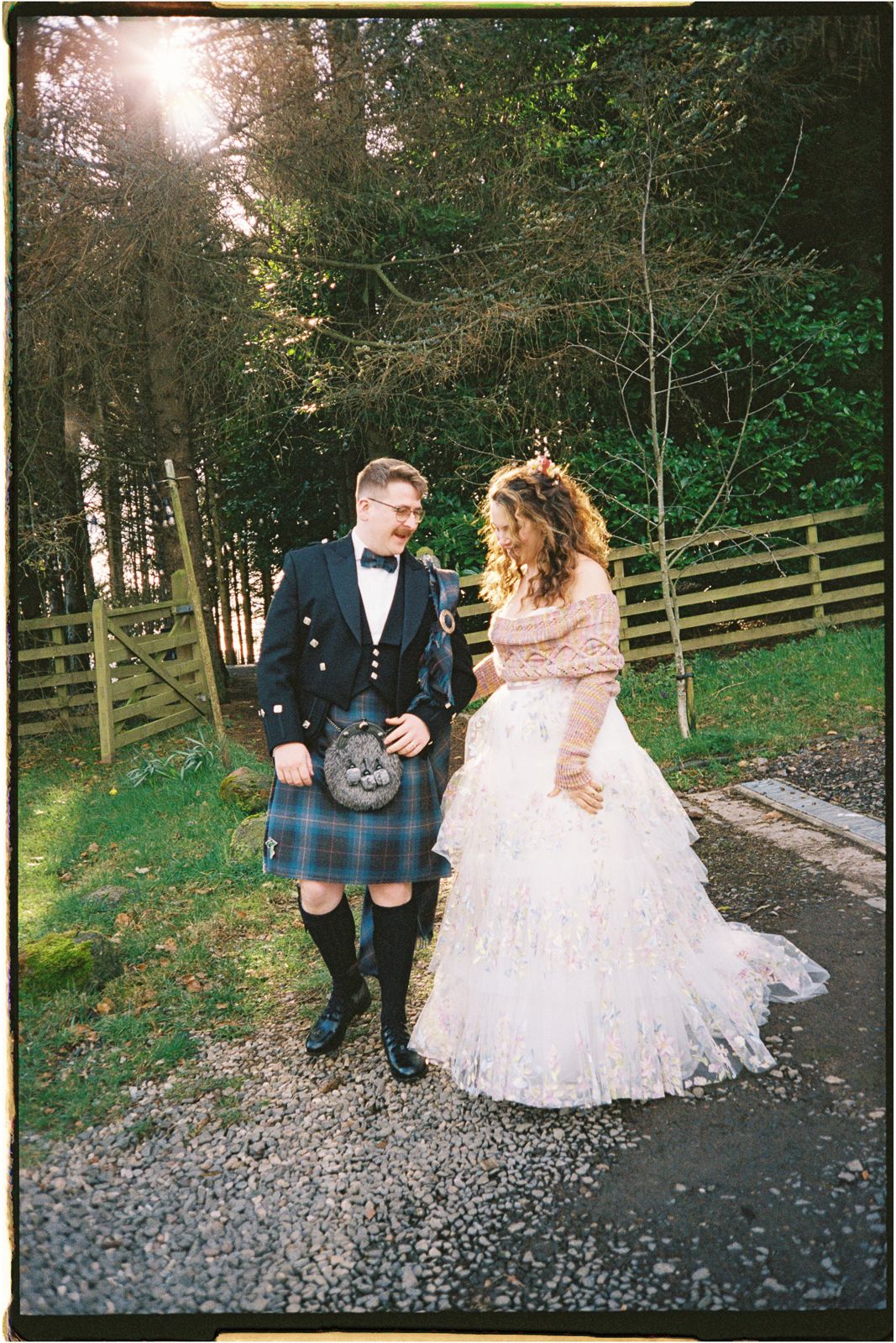 Bride and groom walking together at Guardswell Farm, shot on 35mm film