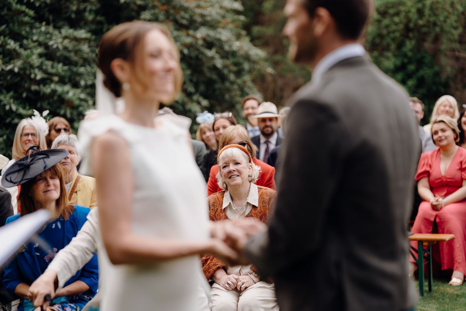 Candid moment of the mother of the bride watching her daughter's wedding ceremony at an outdoor wedding in Kailzie Gardens, Peebles
