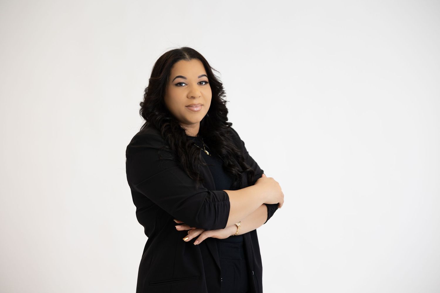 Artistic portrait of woman in black outfit against white background.