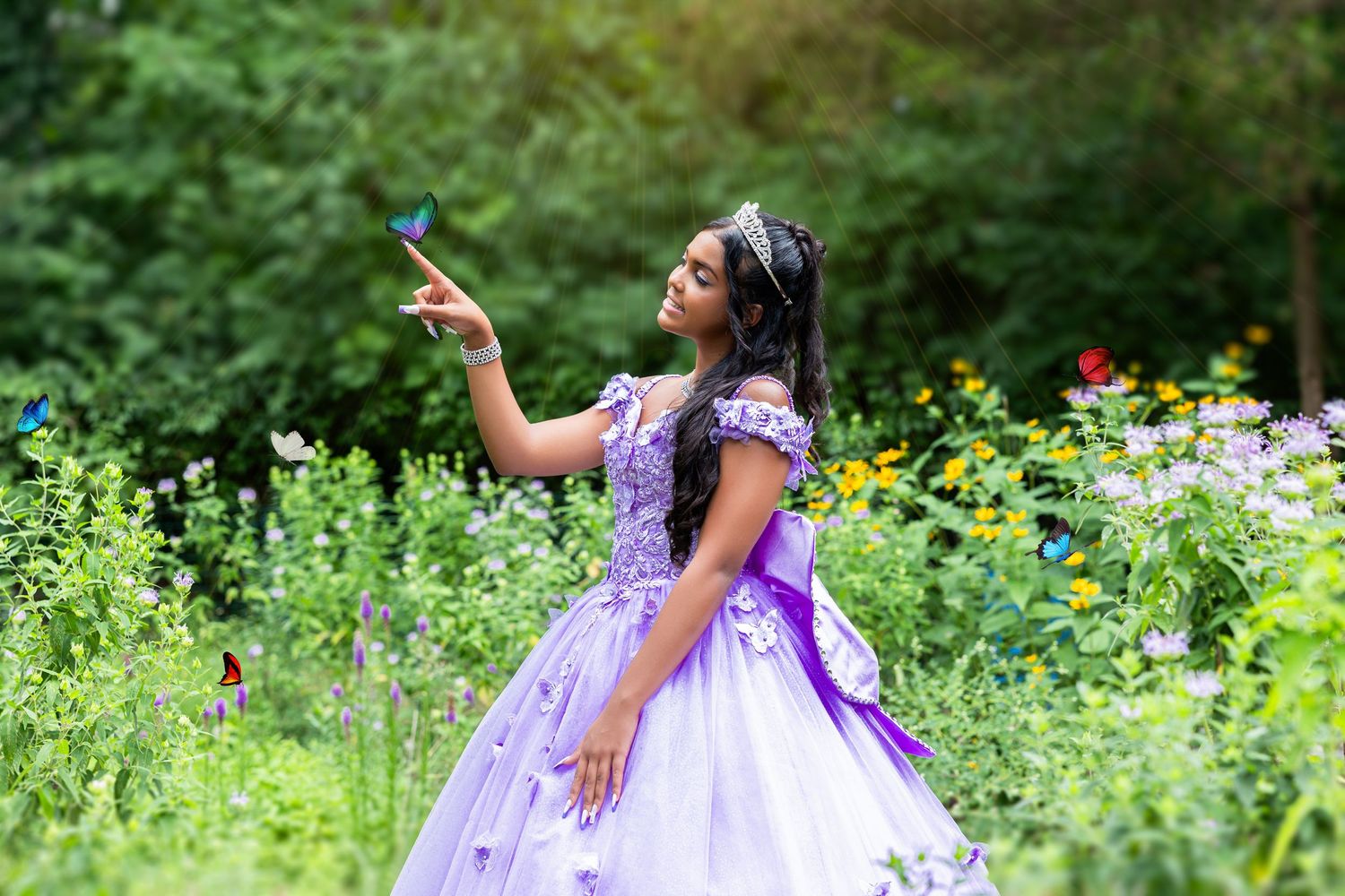 A person wearing a flowing purple gown poses gracefully in a lush garden filled with yellow wildflowers and greenery.