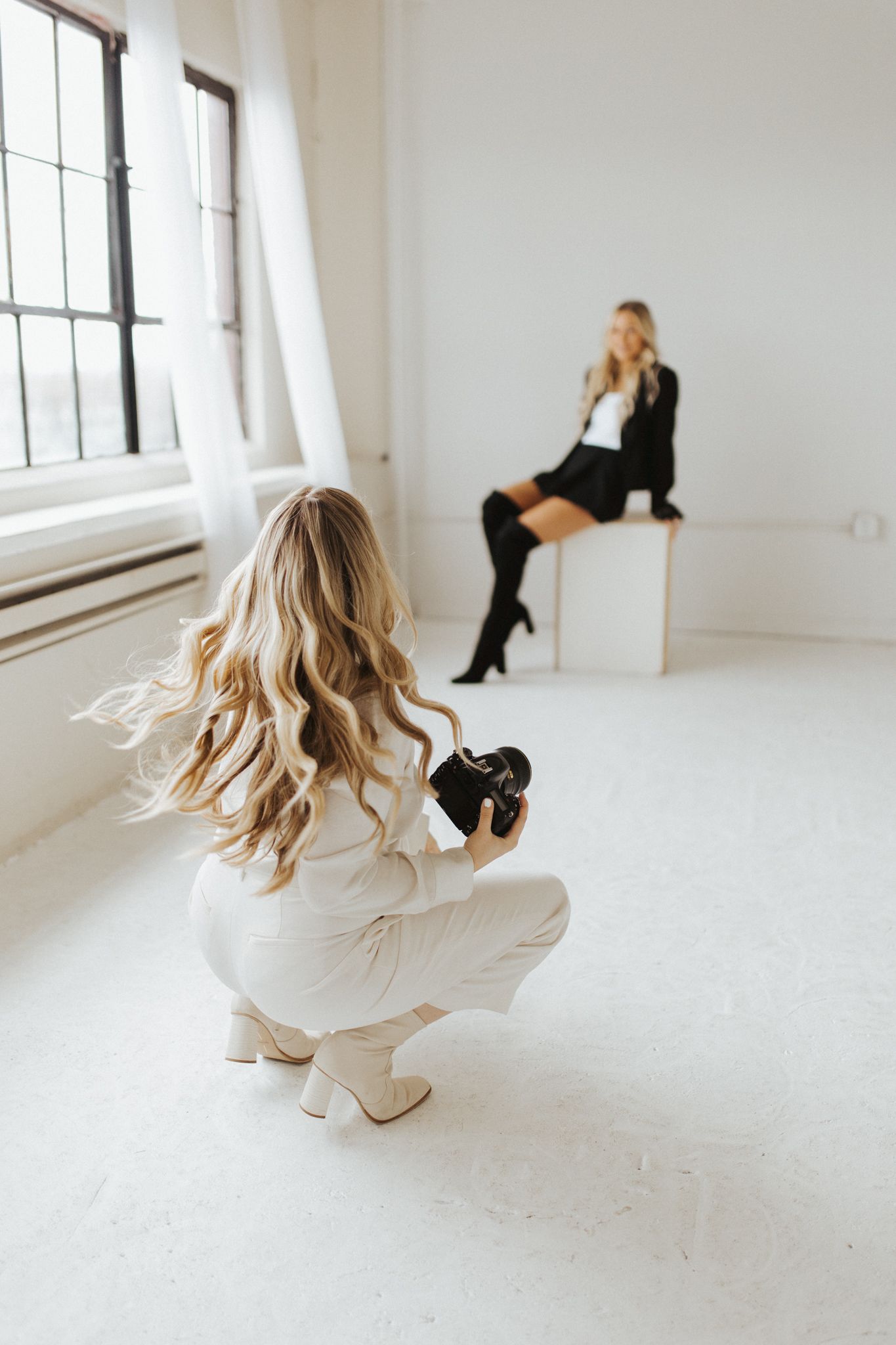 Dynamic fashion poses captured in bright white studio space with natural window lighting.
