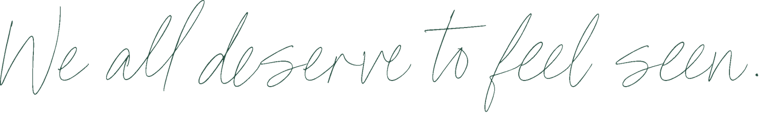 Handwritten cursive text reads 'We all deserve to feel seen'.
