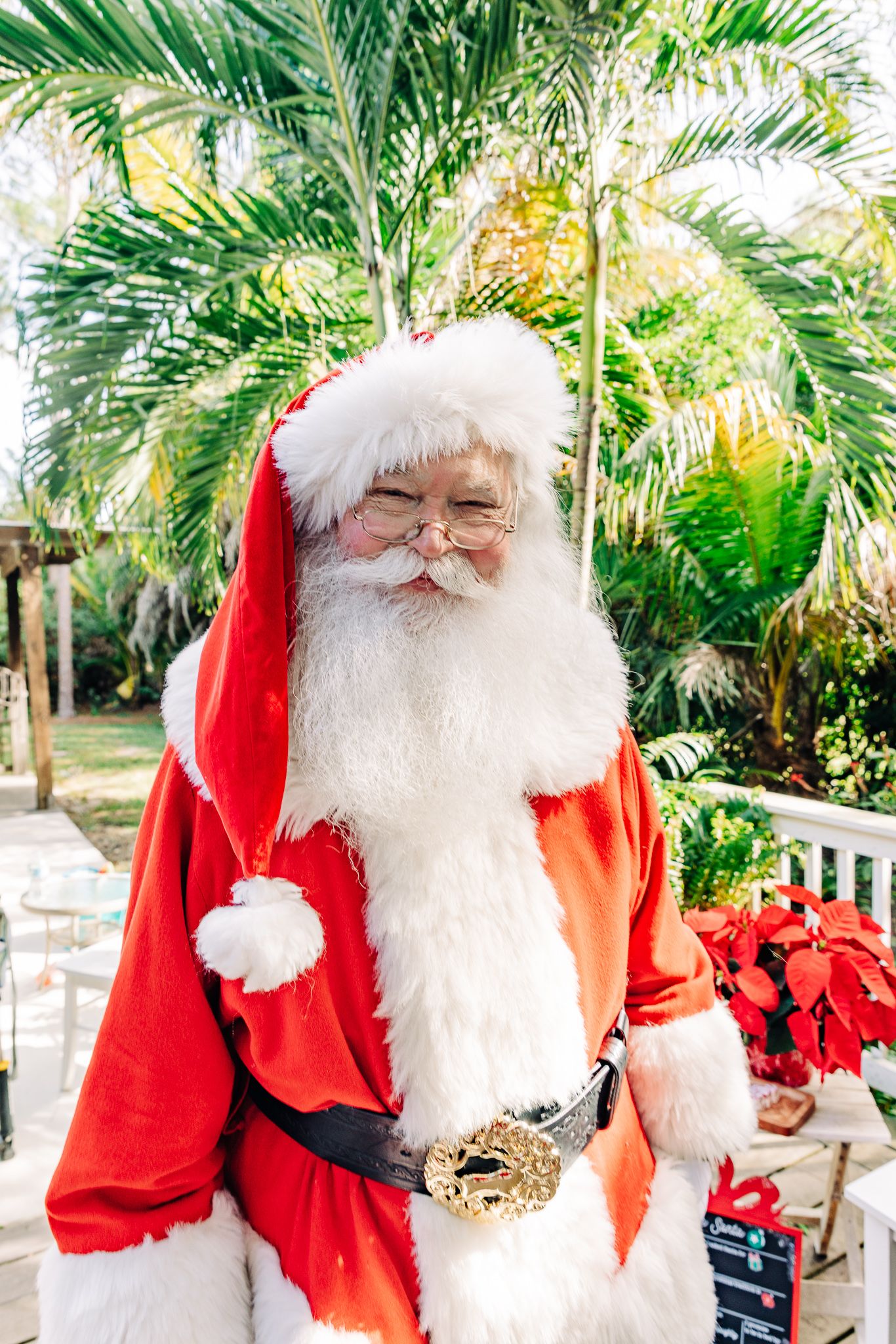 Santa photos in Lake Worth Beach of a young boy hugging Santa Claus during a Christmas experience.