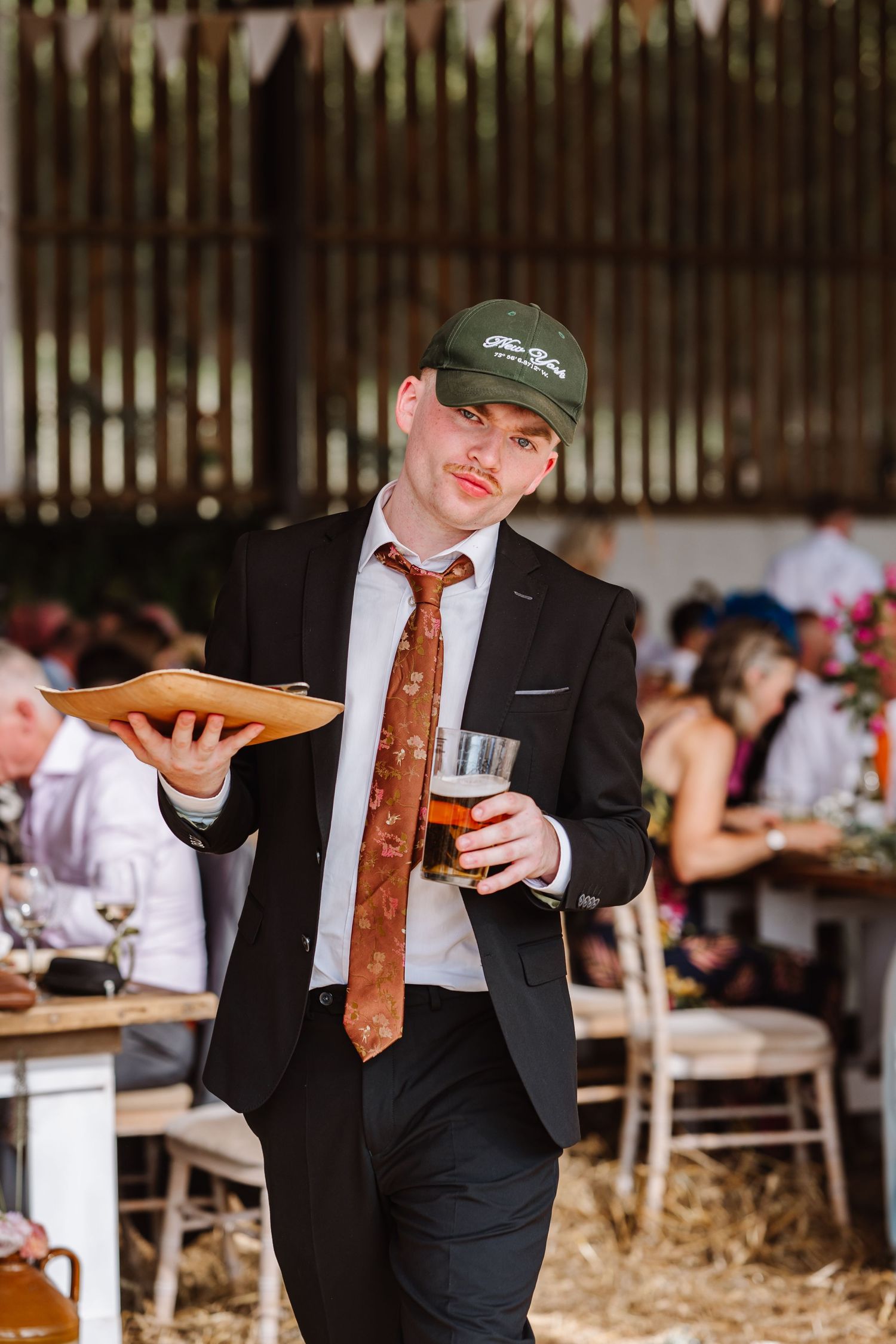 Guests poses for photo Dorset Festival barn wedding at Cerne Abbas Brewery. Candid photos from a relaxed Dorset wedding photographer
