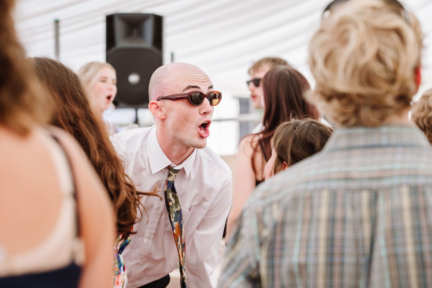 Guests dance Dorset Festival barn wedding at Cerne Abbas Brewery. Candid photos from a relaxed Dorset wedding photographer