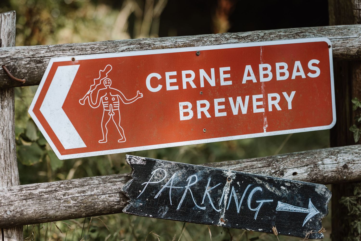 Naked giant sign at Dorset Festival barn wedding at Cerne Abbas Brewery. Candid photos from a relaxed Dorset wedding photographer