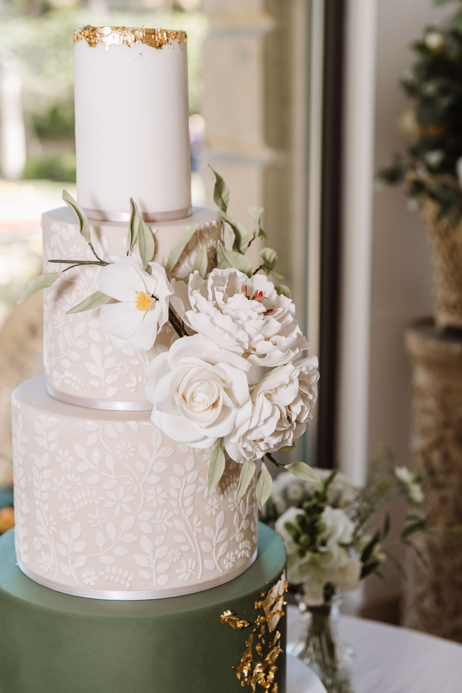 Olives sage green wedding cake with gold leaf and ivory flowers.Italian Villa, Compton Acres Poole from a Dorset candid wedding photographer