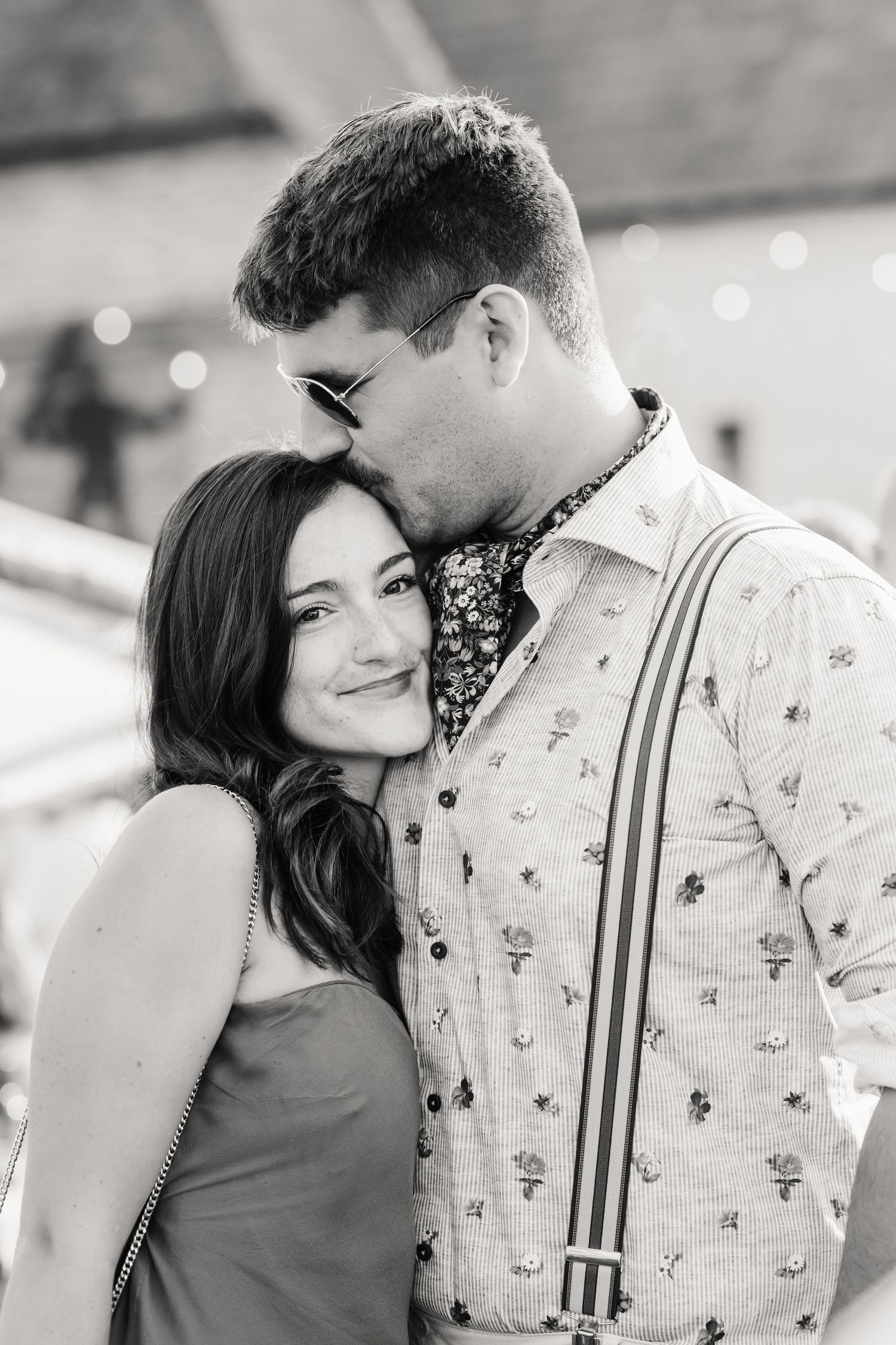 Guests kiss at Dorset Festival barn wedding at Cerne Abbas Brewery. Candid photos from a relaxed Dorset wedding photographer