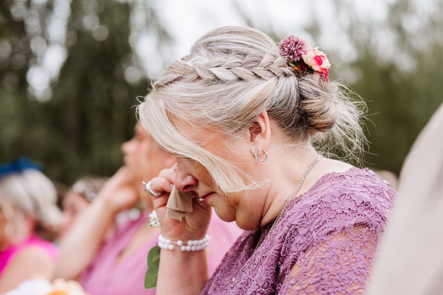 Emotional mother of the bride in pink dress during an outdoor ceremony at Waterside Country Barn and Mill. Relaxed Somerset Wedding photos