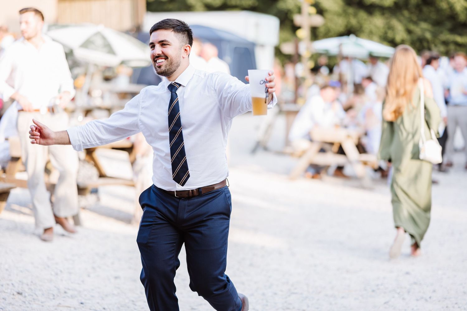 Guest celebrates at Dorset Festival barn wedding at Cerne Abbas Brewery. Candid photos from a relaxed Dorset wedding photographer