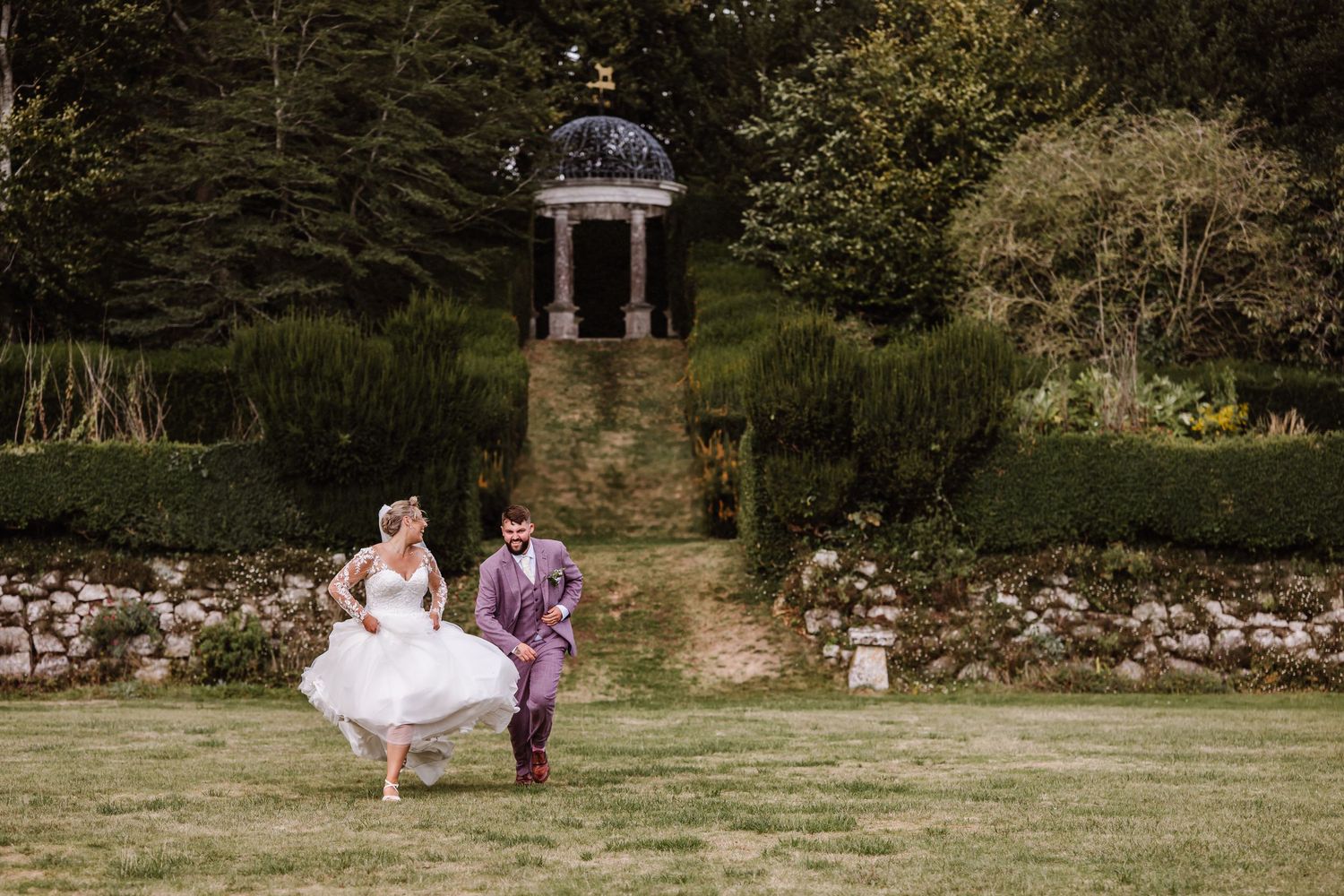 Candid photo of a playful bride and groom. Candid wedding photographer Dorset. Photo taken at Kingston Maurward Estate, Dorchester