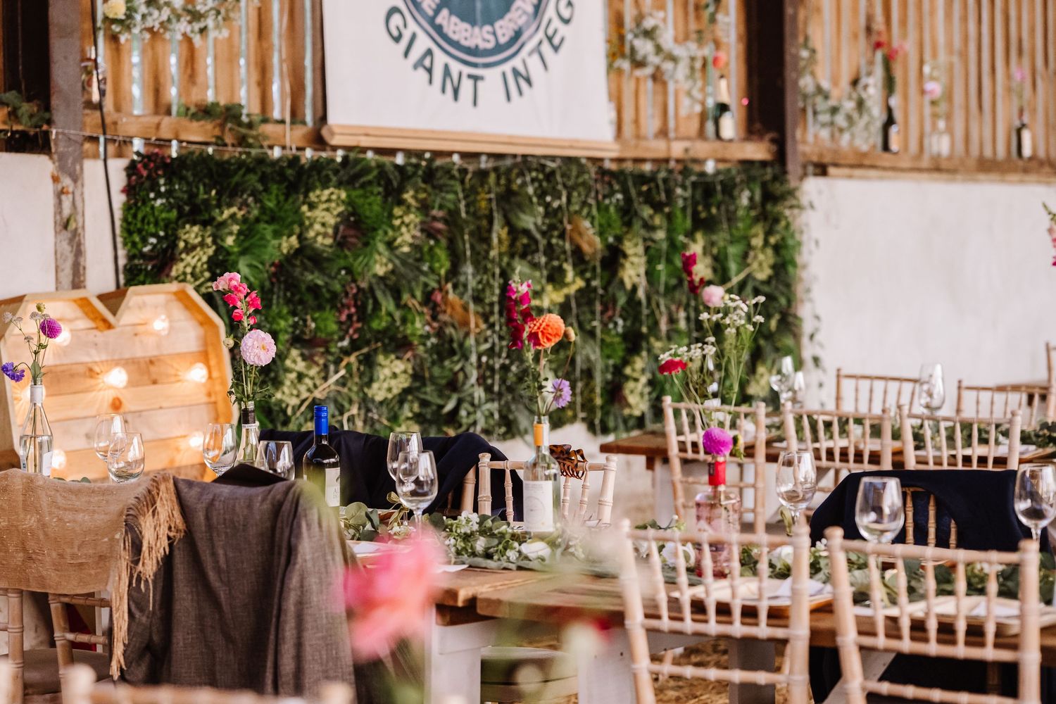 Boho chairs and flowers Dorset Festival barn wedding at Cerne Abbas Brewery. Candid photos from a relaxed Dorset wedding photographer