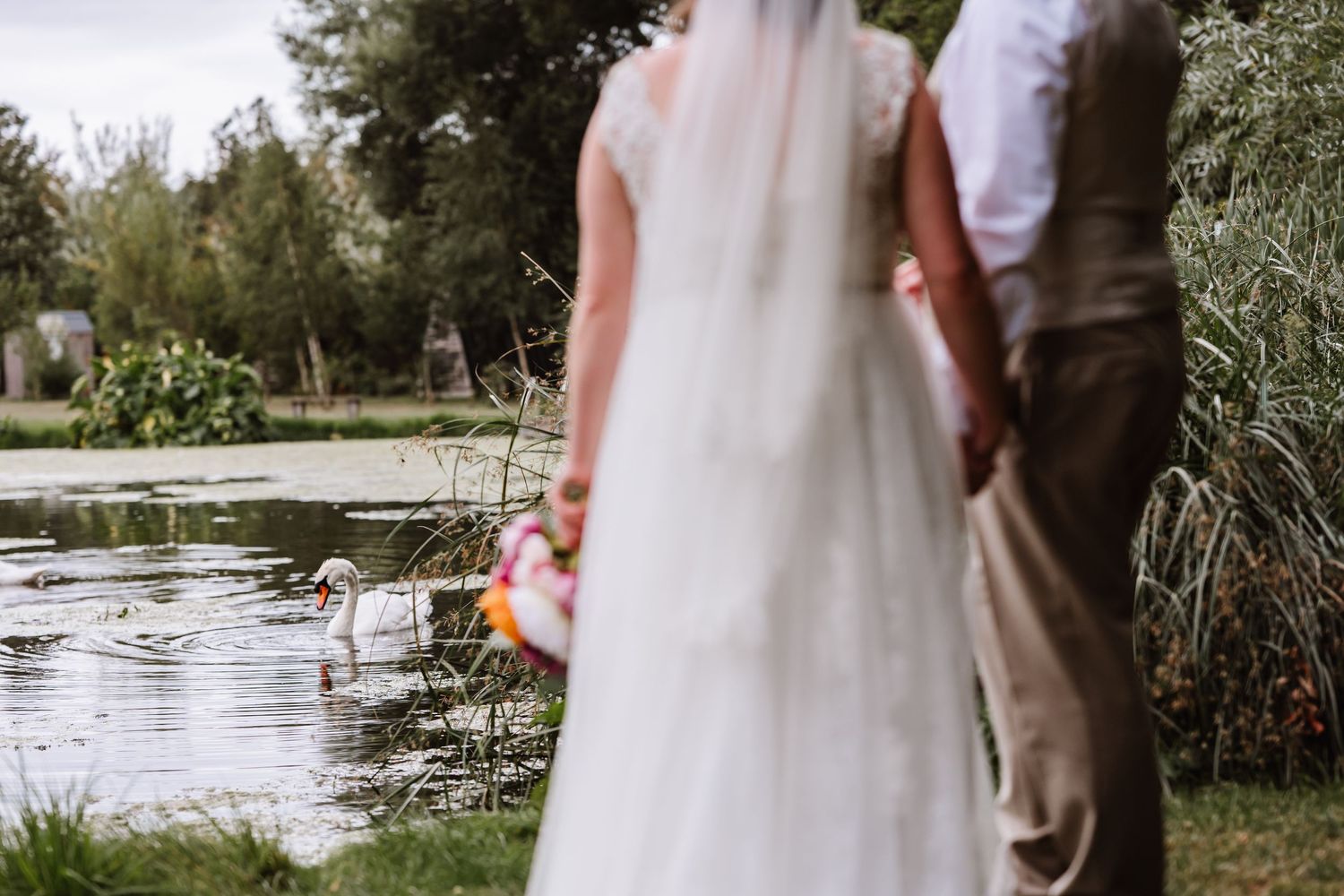 Bride and Groom at Waterside Country Barn and Mill near Taunton. Outdoor wedding venue and barn Somerset. Somerset candid wedding photograph