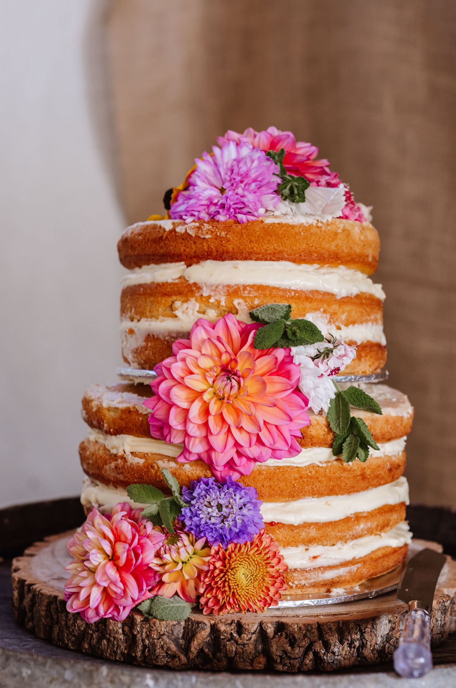 Naked wedding cake at Dorset Festival barn wedding at Cerne Abbas Brewery. Candid photos from a relaxed Dorset wedding photographer