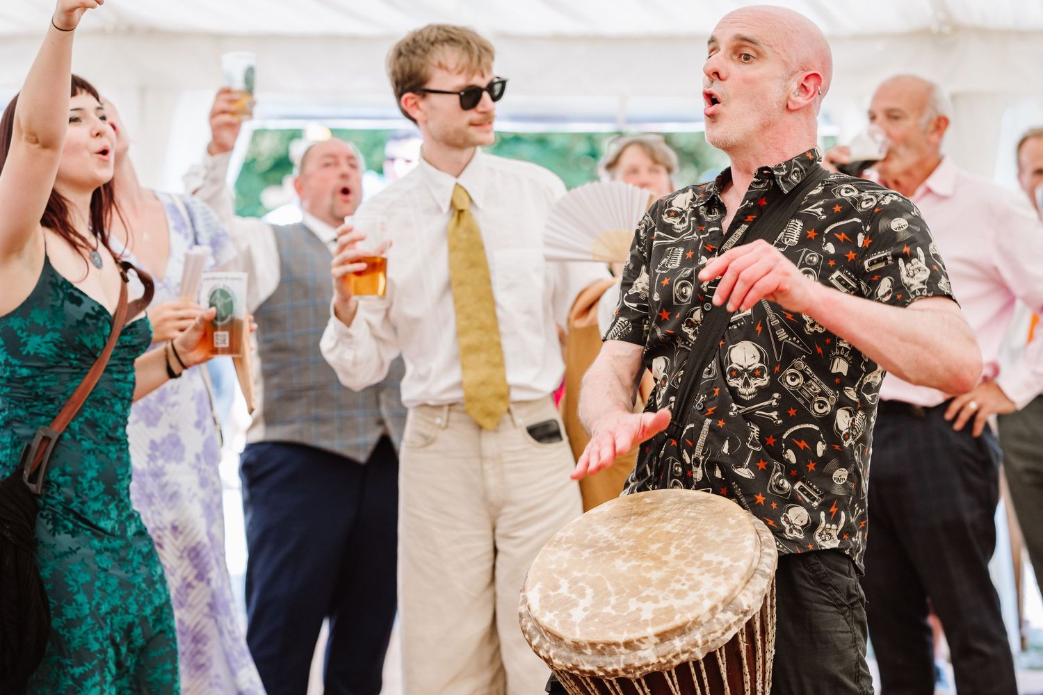 Band plays at Dorset Festival barn wedding at Cerne Abbas Brewery. Candid photos from a relaxed Dorset wedding photographer