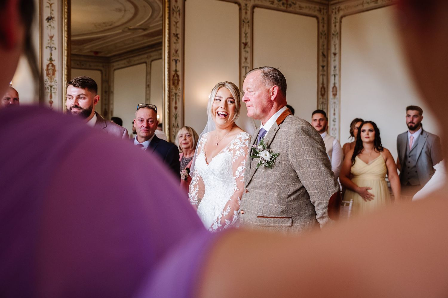 Bride and her father walk the aisle at a Kingston Maurward Estate a wedding venue Dorchester from a candid wedding photographer Weymouth