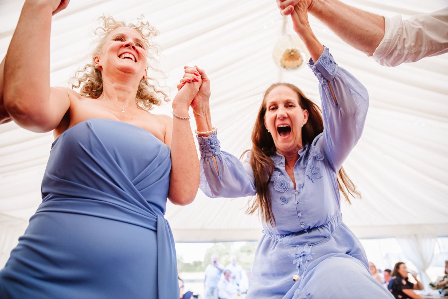 Guests dance at Dorset Festival barn wedding at Cerne Abbas Brewery. Candid photos from a relaxed Dorset wedding photographer