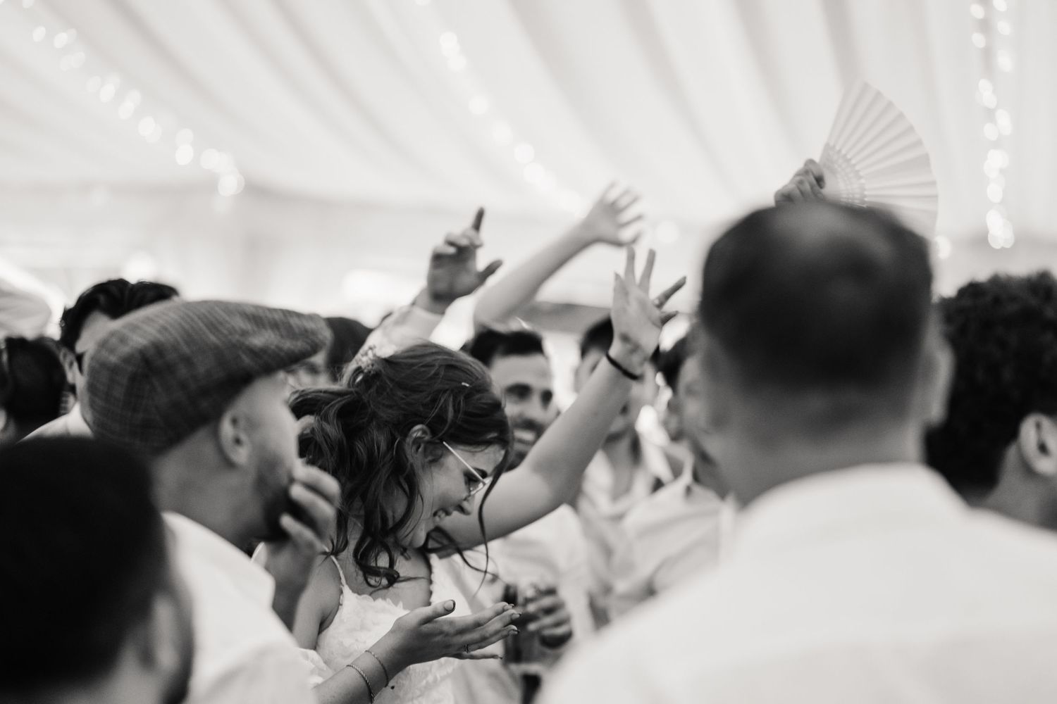 Bride and guests dance at Dorset Festival barn wedding at Cerne Abbas Brewery. Candid photos from a relaxed Dorset wedding photographer