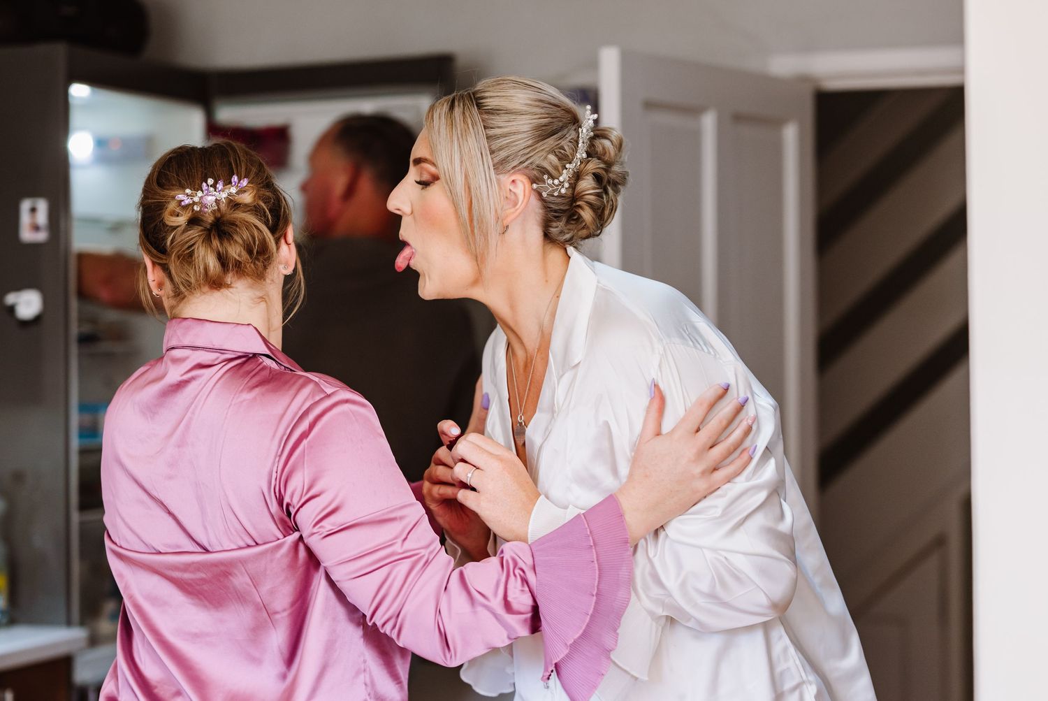 candid photography of a Bride and maid of honour from a Dorset wedding photographer based in Weymouth. Relaxed Dorset Wedding photographer