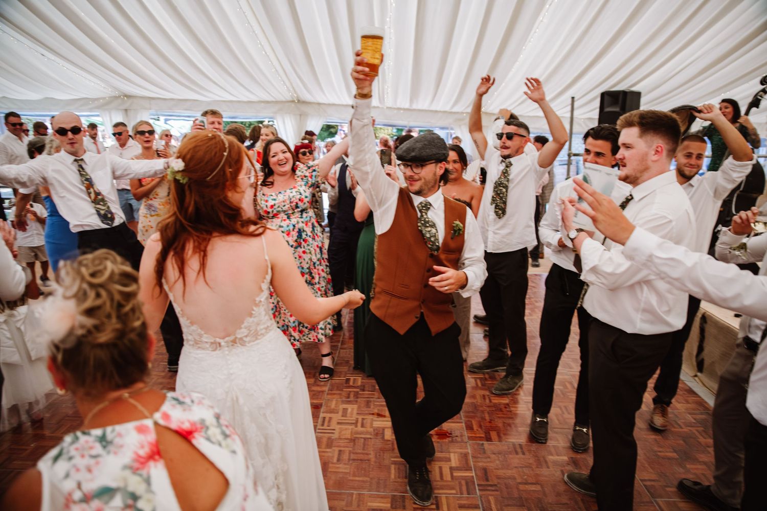 Bride and Groom dance at Dorset Festival barn wedding at Cerne Abbas Brewery. Candid photos from a relaxed Dorset wedding photographer