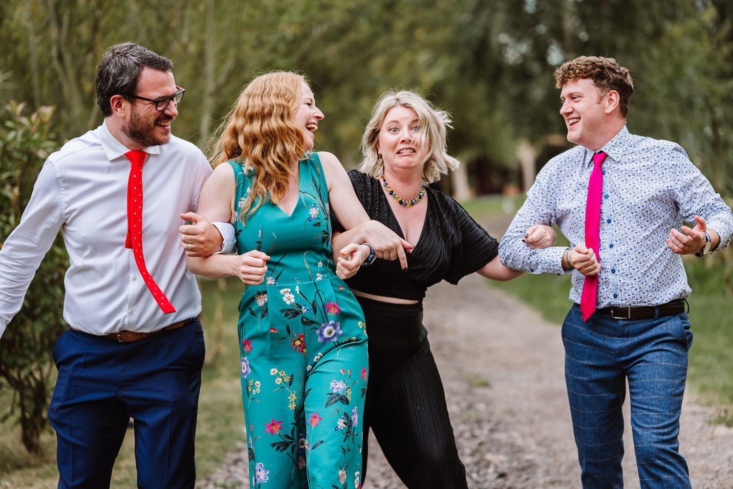 Wedding guests laughing at the Waterside Country Barn and Mill, Taunton Outdoor Barn wedding venue with lake. Wedding photographer Somerset