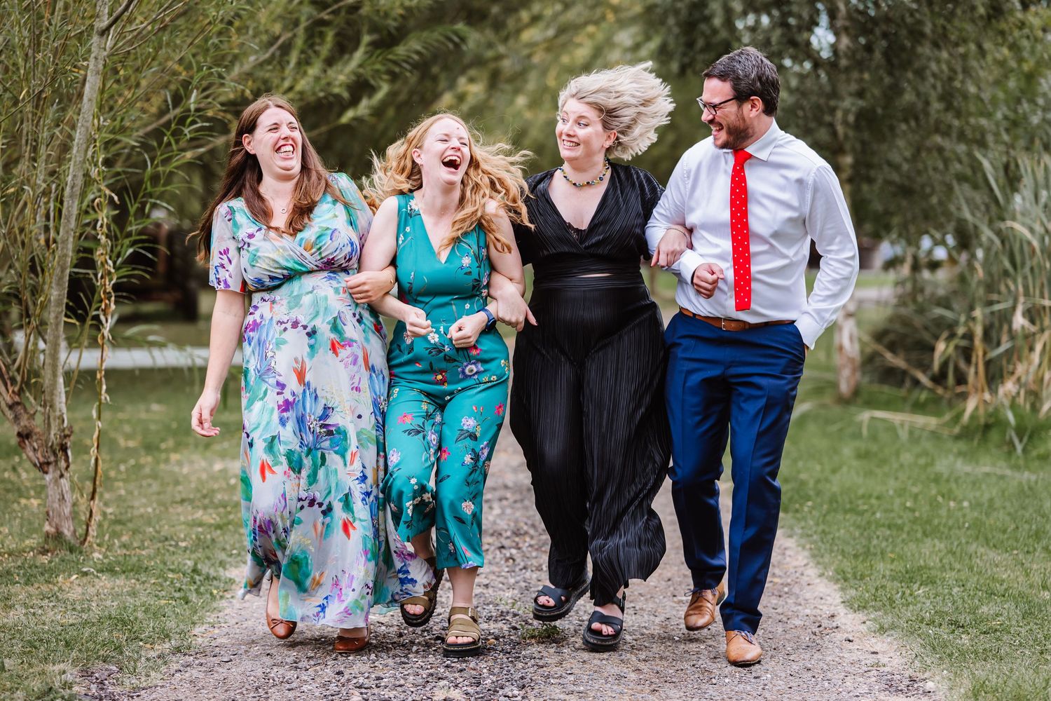 Wedding guests laughing at the Waterside Country Barn and Mill, Taunton Outdoor Barn wedding venue with lake. Wedding photographer Somerset