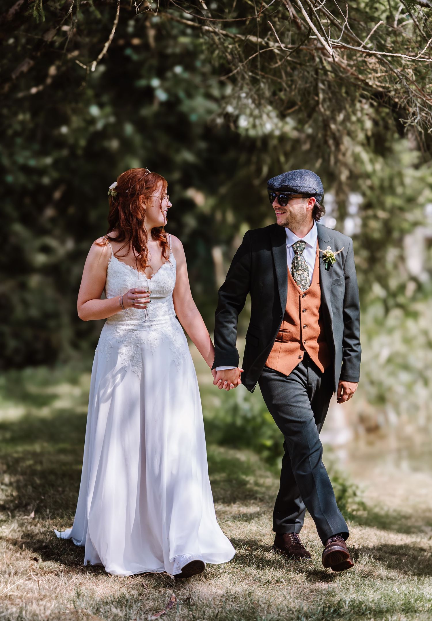 Bride and Groom portraits. Groom is wearing flat cap and brown waist coat. Dorset Candid wedding photographer