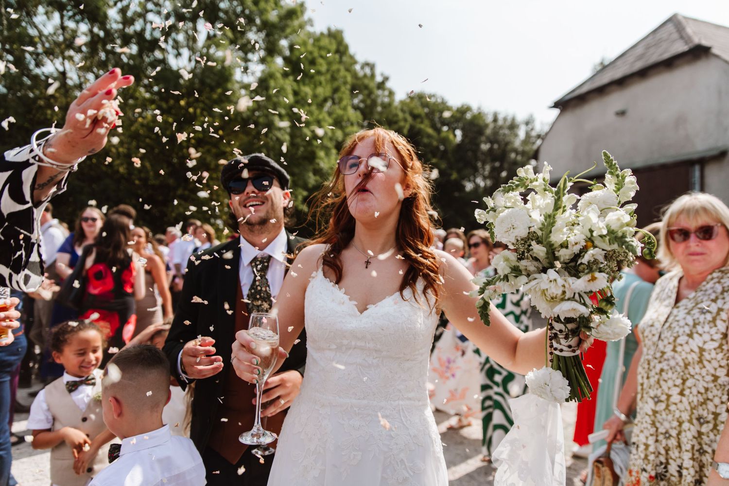 Confetti shot at Dorset Festival barn wedding at Cerne Abbas Brewery. Candid photos from a relaxed Dorset wedding photographer