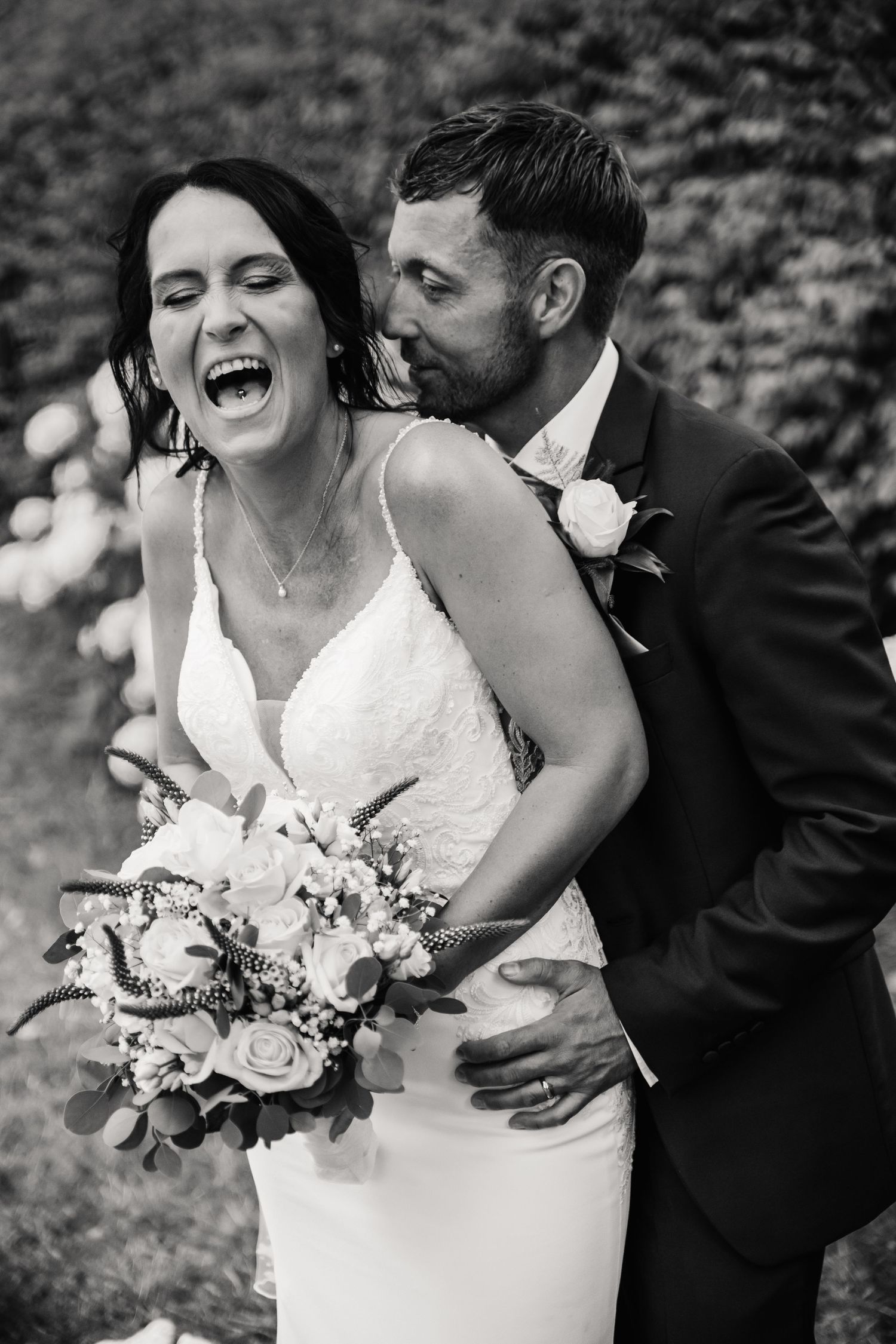 Black and white photo of a Weymouth wedding couple. Weymouth wedding bride laughs candidly