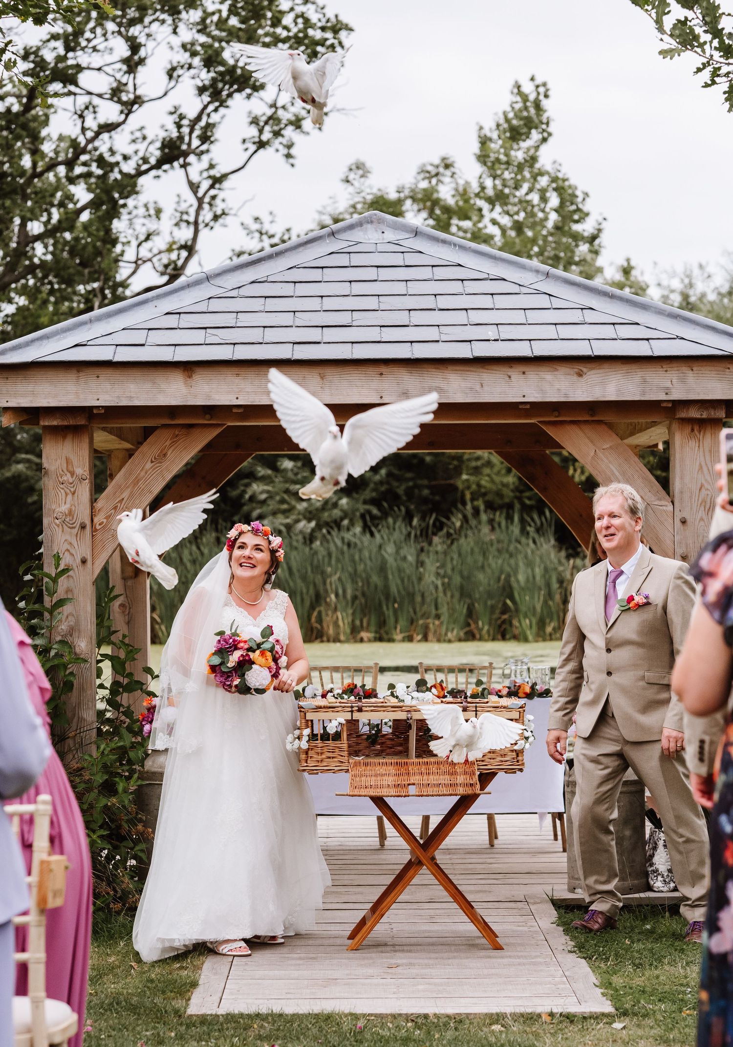 White doves released during an outdoor wedding at the Waterside Country Barn and Mill, wedding venue near Taunton.