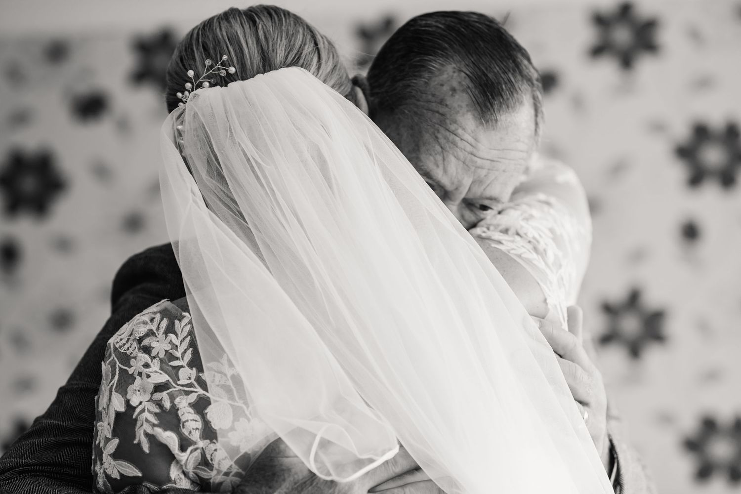 Bride and father hug at their first look. Candid wedding photographer based in Weymouth, Dorset