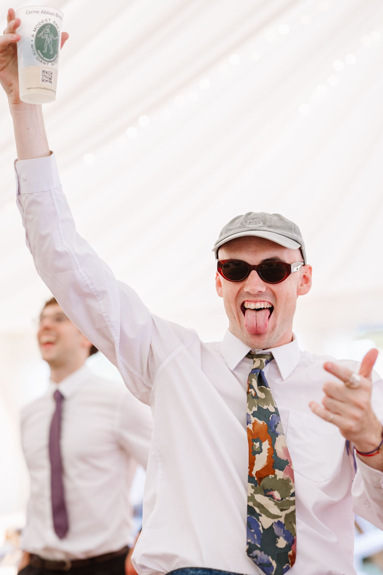 Guest dances at Dorset Festival barn wedding at Cerne Abbas Brewery. Candid photos from a relaxed Dorset wedding photographer