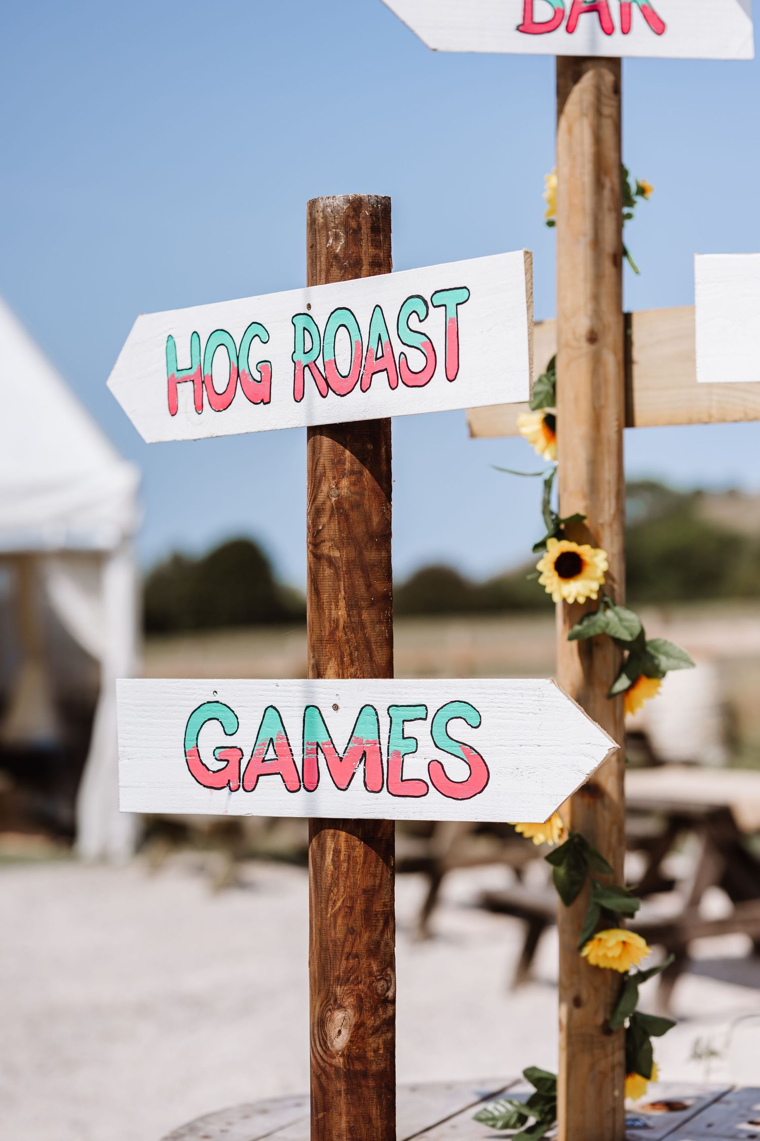Wedding signs at Dorset Festival barn wedding at Cerne Abbas Brewery. Candid photos from a relaxed Dorset wedding photographer