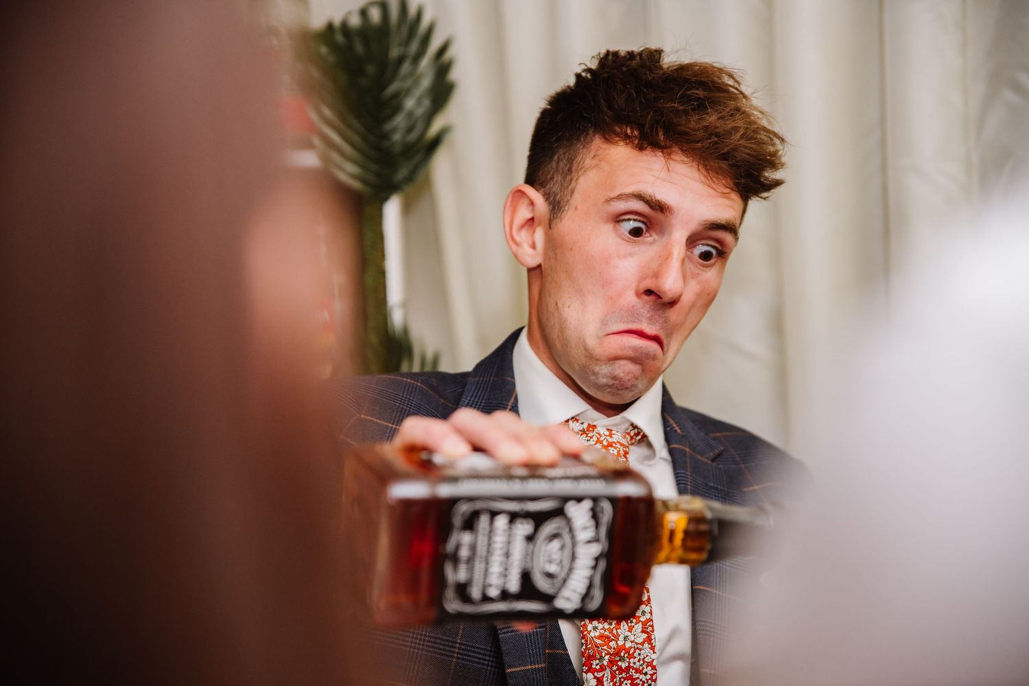 Groom pours drinks at an Abbotsbury Gardens wedding.  Outdoor wedding venue in Dorset.  Candid Weymouth wedding photographer