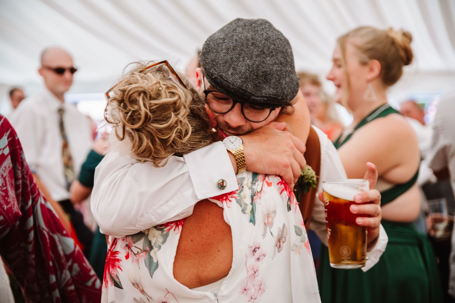 Groom and his mum hug at Dorset Festival barn wedding at Cerne Abbas Brewery. Candid photos from a relaxed Dorset wedding photographer