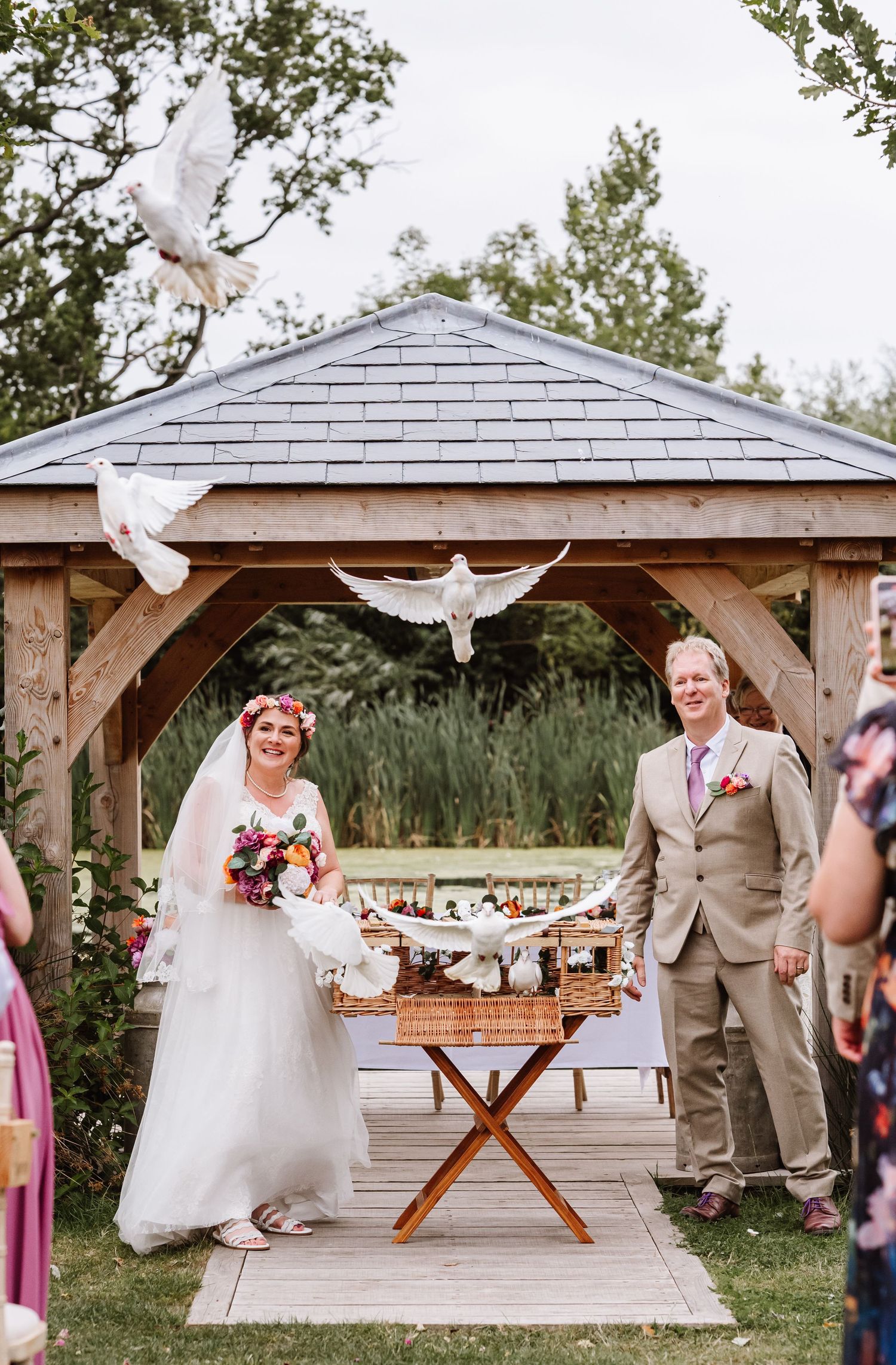 White doves released during an outdoor wedding at the Waterside Country Barn and Mill, wedding venue near Taunton. Relaxed Somerset Wedding