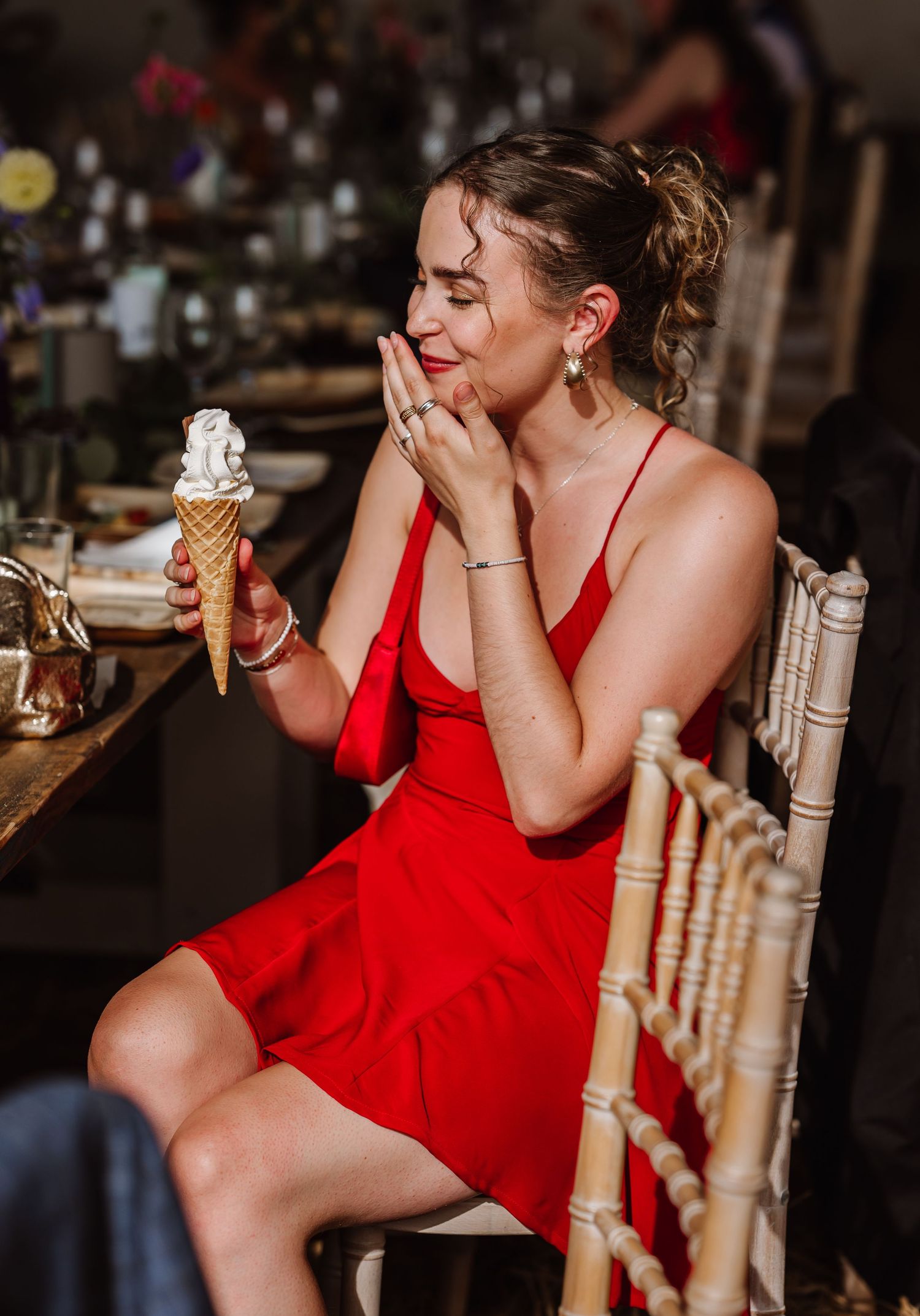 Guest enjoys ice cream at Dorset Festival barn wedding at Cerne Abbas Brewery. Candid photos from a relaxed Dorset wedding photographer