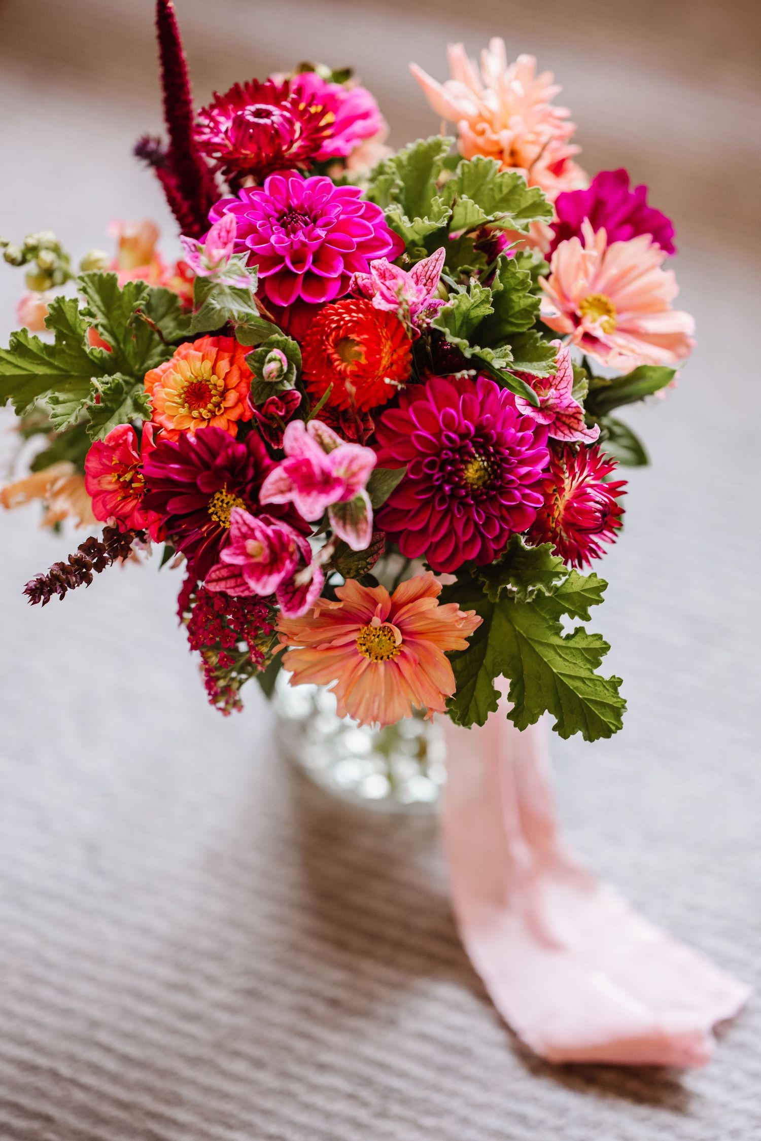 Pink, orange wedding bouquet at Winchester Westgate wedding. Candid wedding photographer Hampshire and Wiltshire.