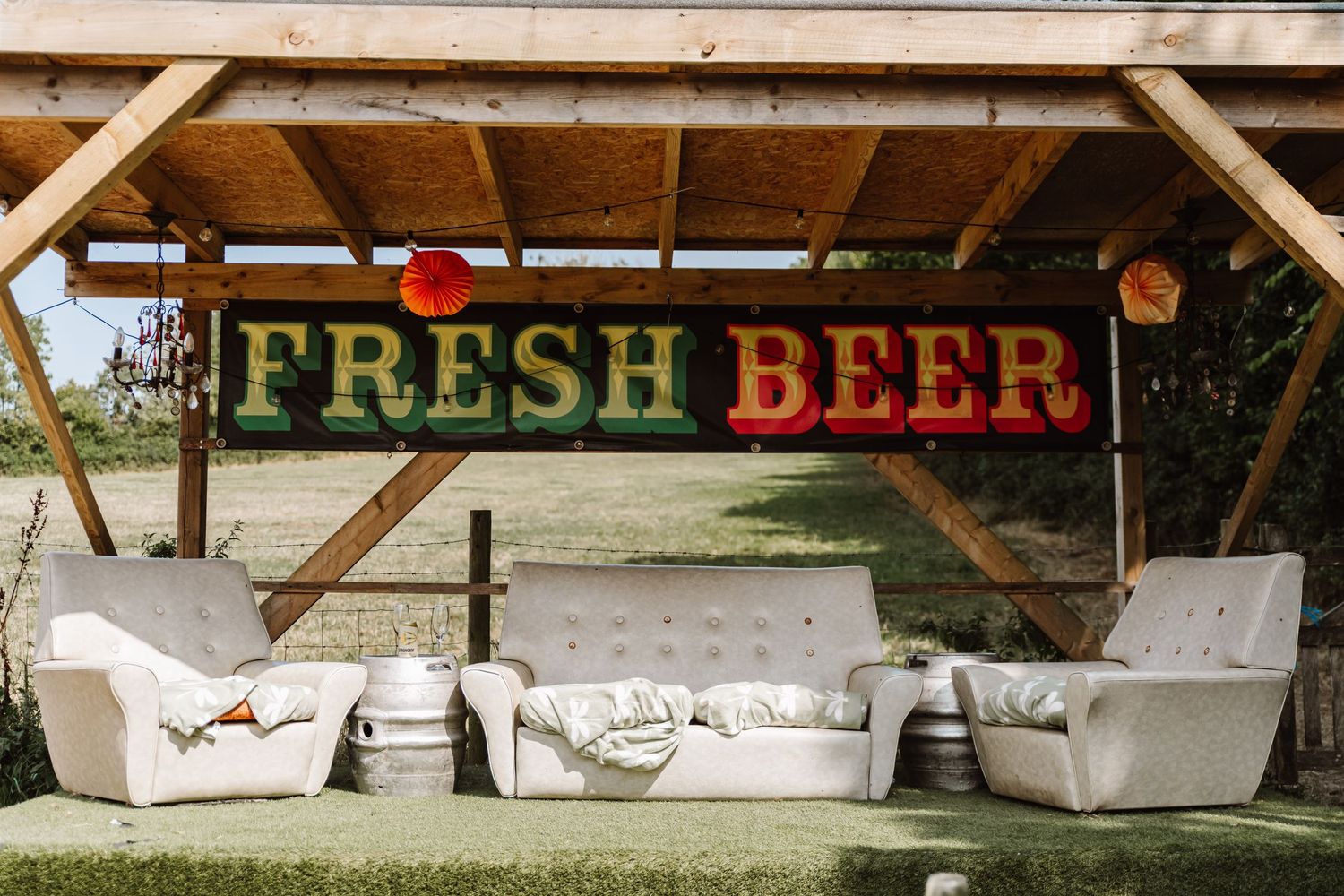 Cerne Abbas Brewery wedding. Outdoor sofas at wedding. Rustic wedding decorations. Dorset Candid wedding photographer