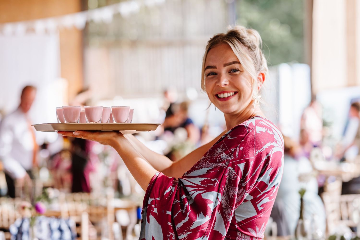 Guest poses with shots at Dorset Festival barn wedding at Cerne Abbas Brewery. Candid photos from a relaxed Dorset wedding photographer