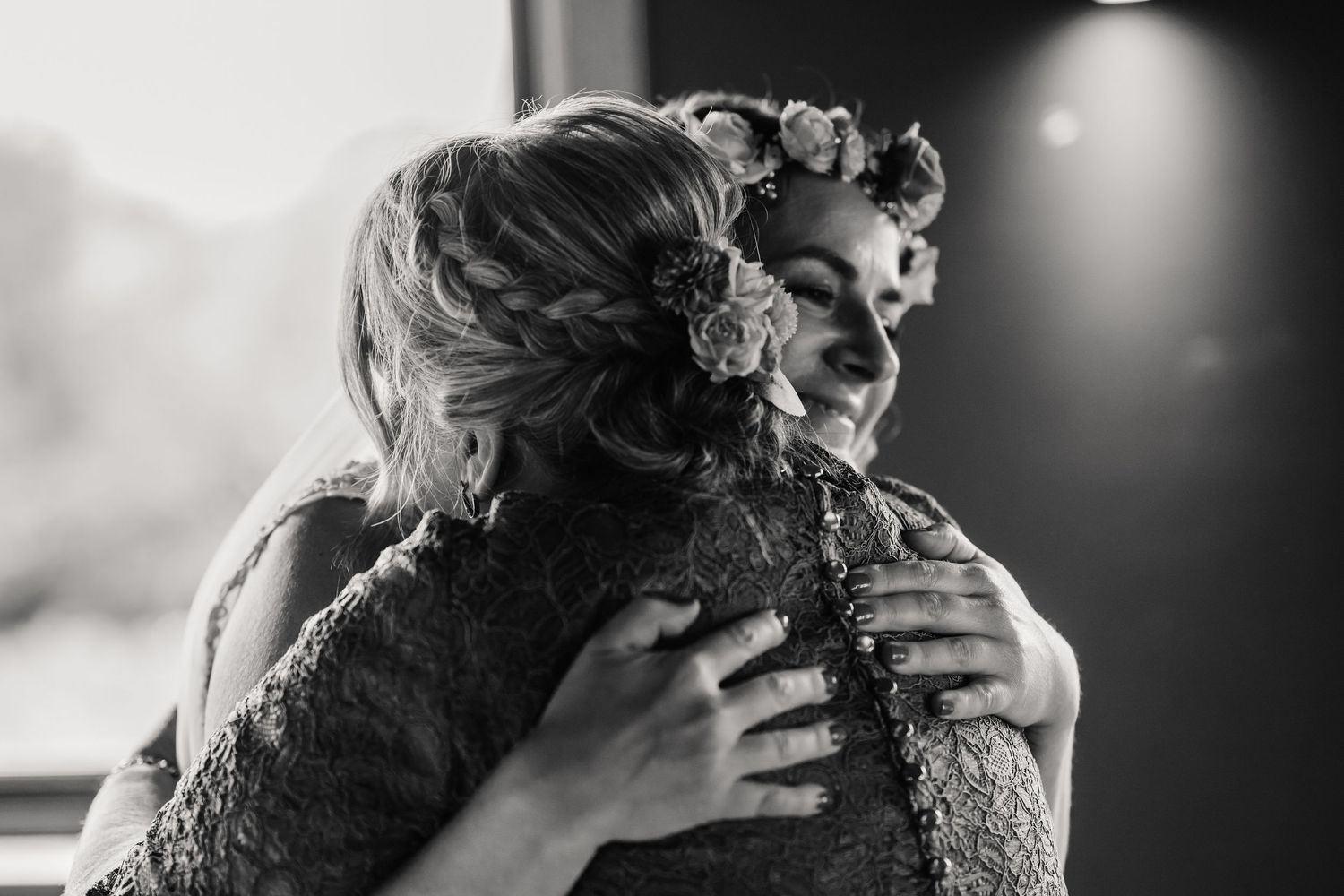 Bride and mum embrace at the Waterside Country Barn and Mill, Taunton Outdoor Barn wedding venue with lake. Wedding photographer Somerset