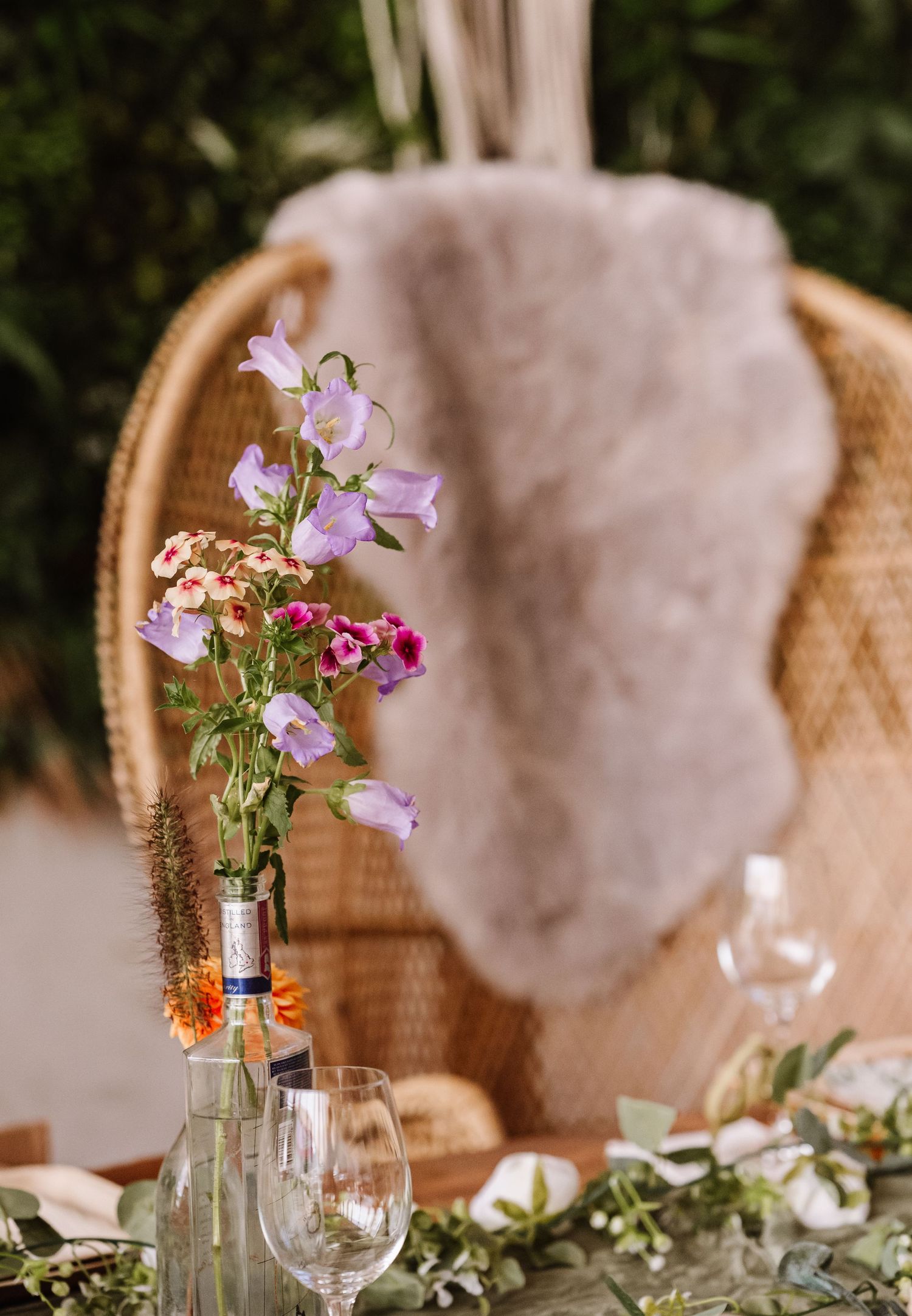 Boho chairs and flowers Dorset Festival barn wedding at Cerne Abbas Brewery. Candid photos from a relaxed Dorset wedding photographer