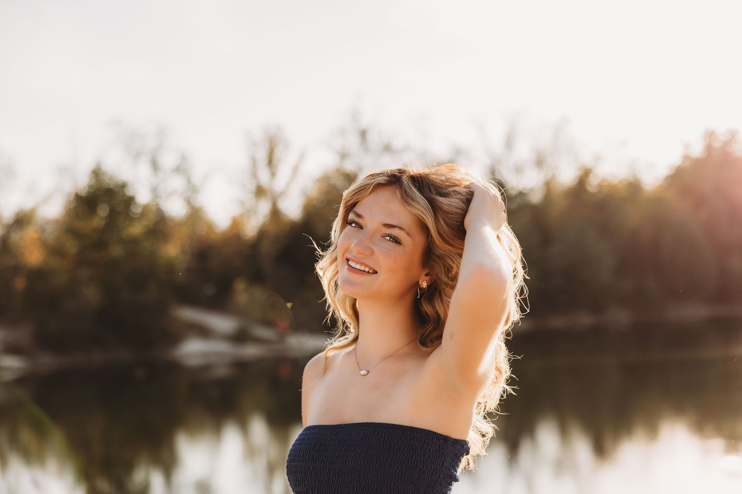 senior girl Klondike park sunset golden hour water in background blonde hair trees