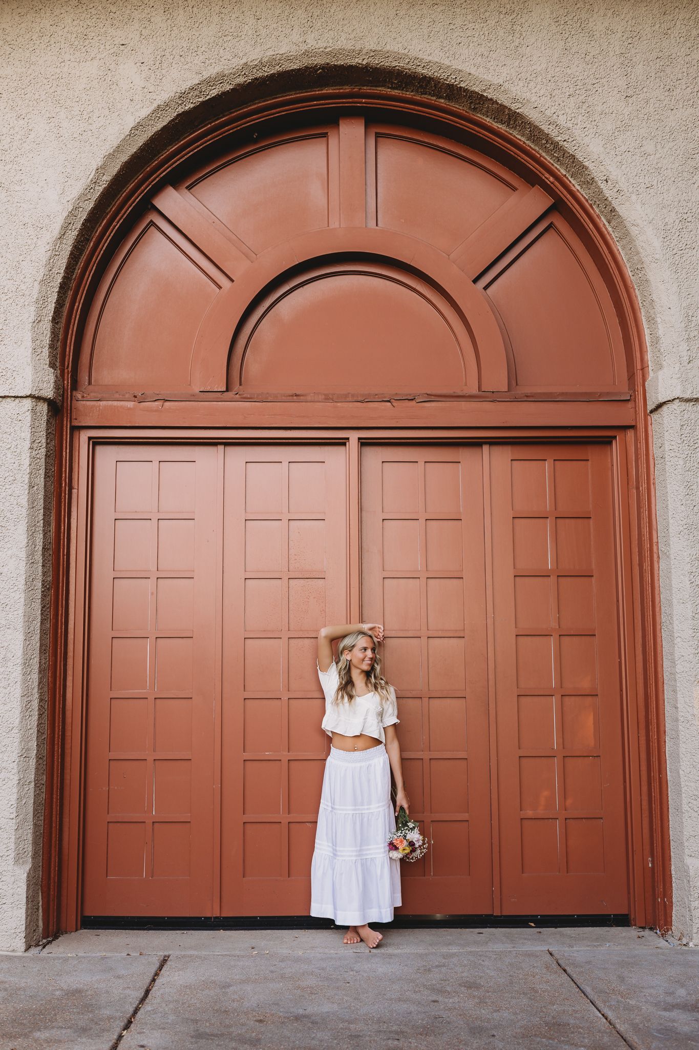 senior girl forest park pavilion big orange rust color arched doorway