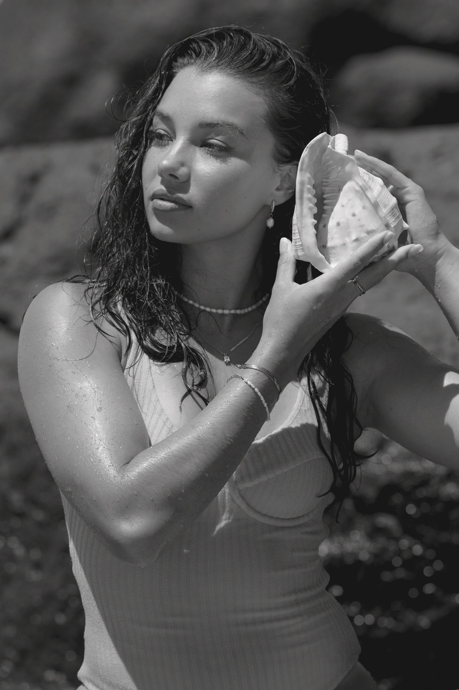 Black and white artistic portrait series showing a person posing with wet hair in dramatic lighting.
