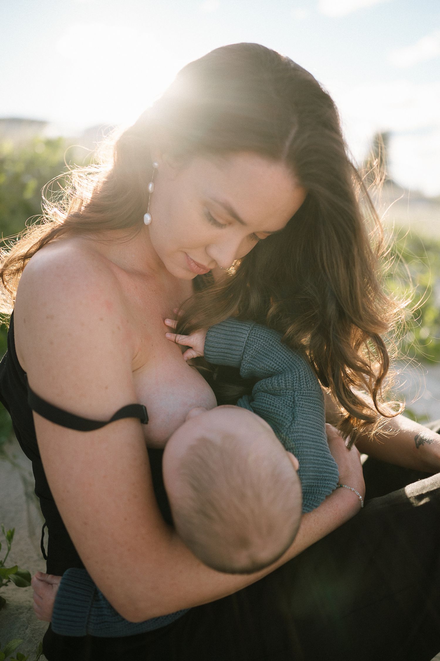 An intimate moment captured in golden sunlight outdoors.