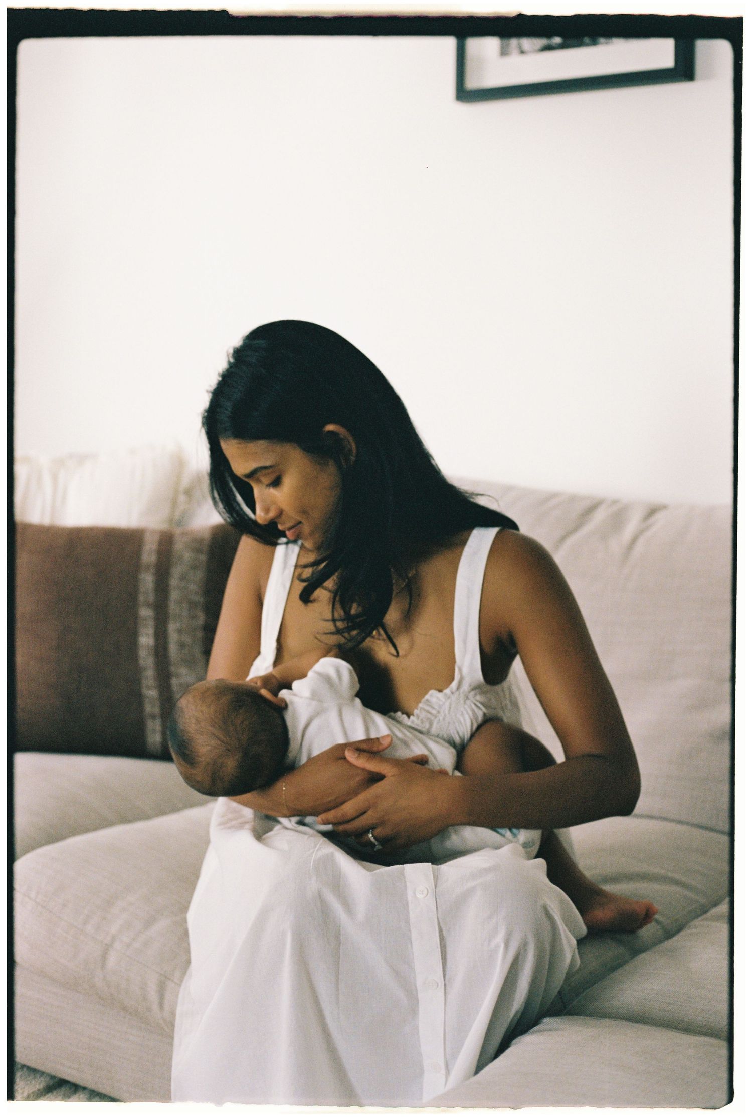 Intimate black and white photography series capturing tender nursing moments.