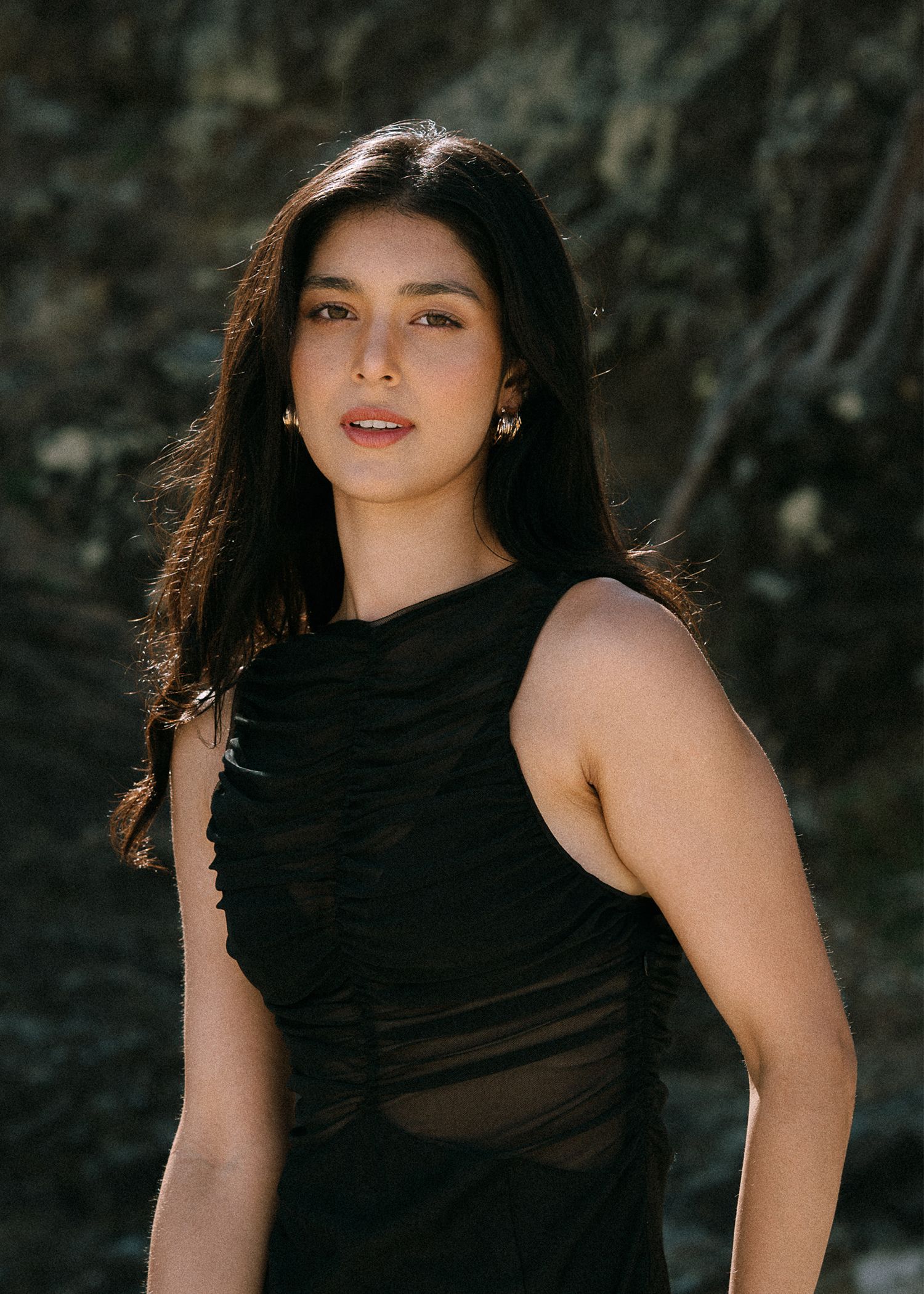 Fashion photo series showing artistic poses against dark textured background in black clothing.
