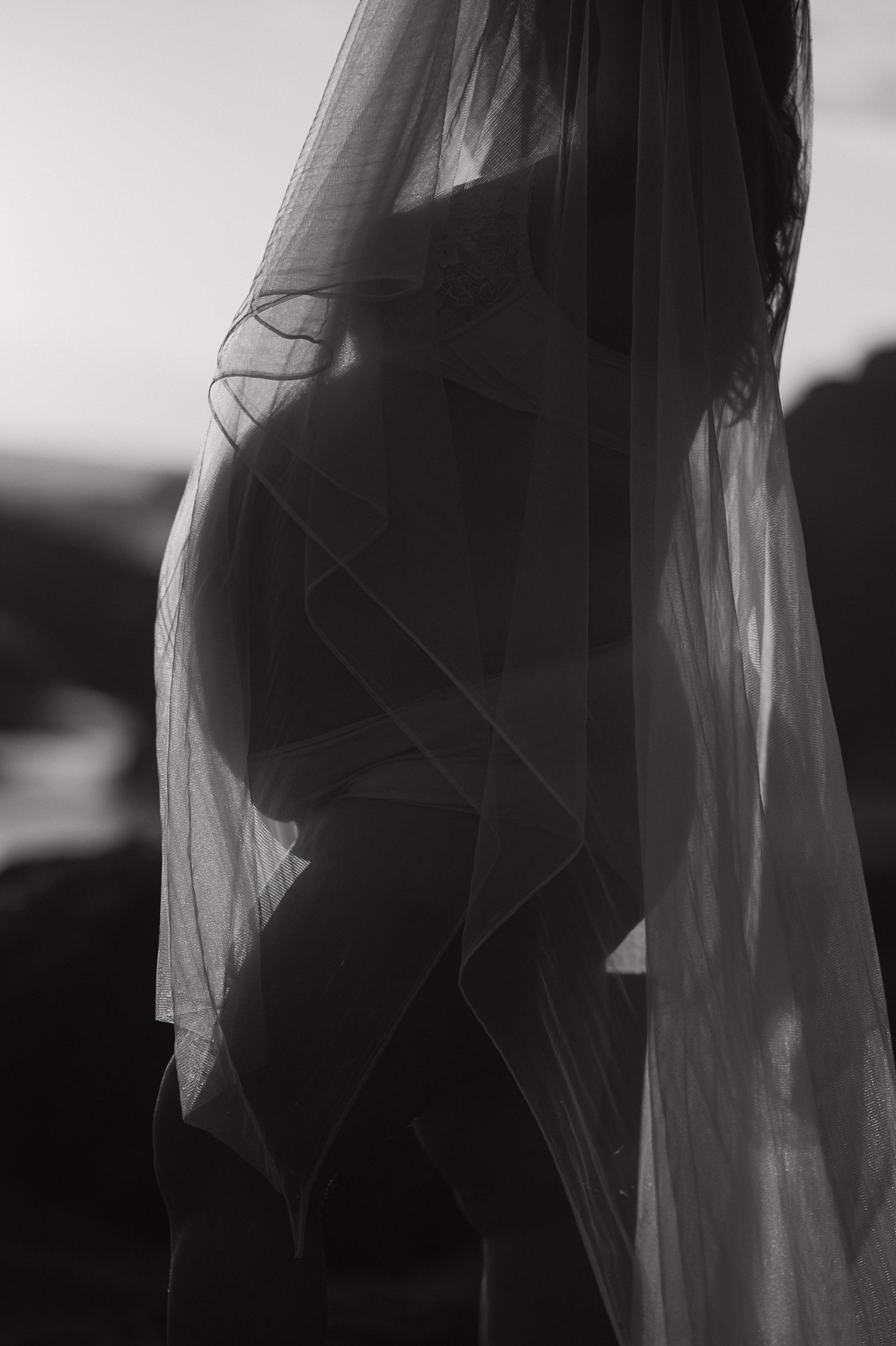 Ethereal black and white photos with flowing fabric creating mysterious silhouettes.