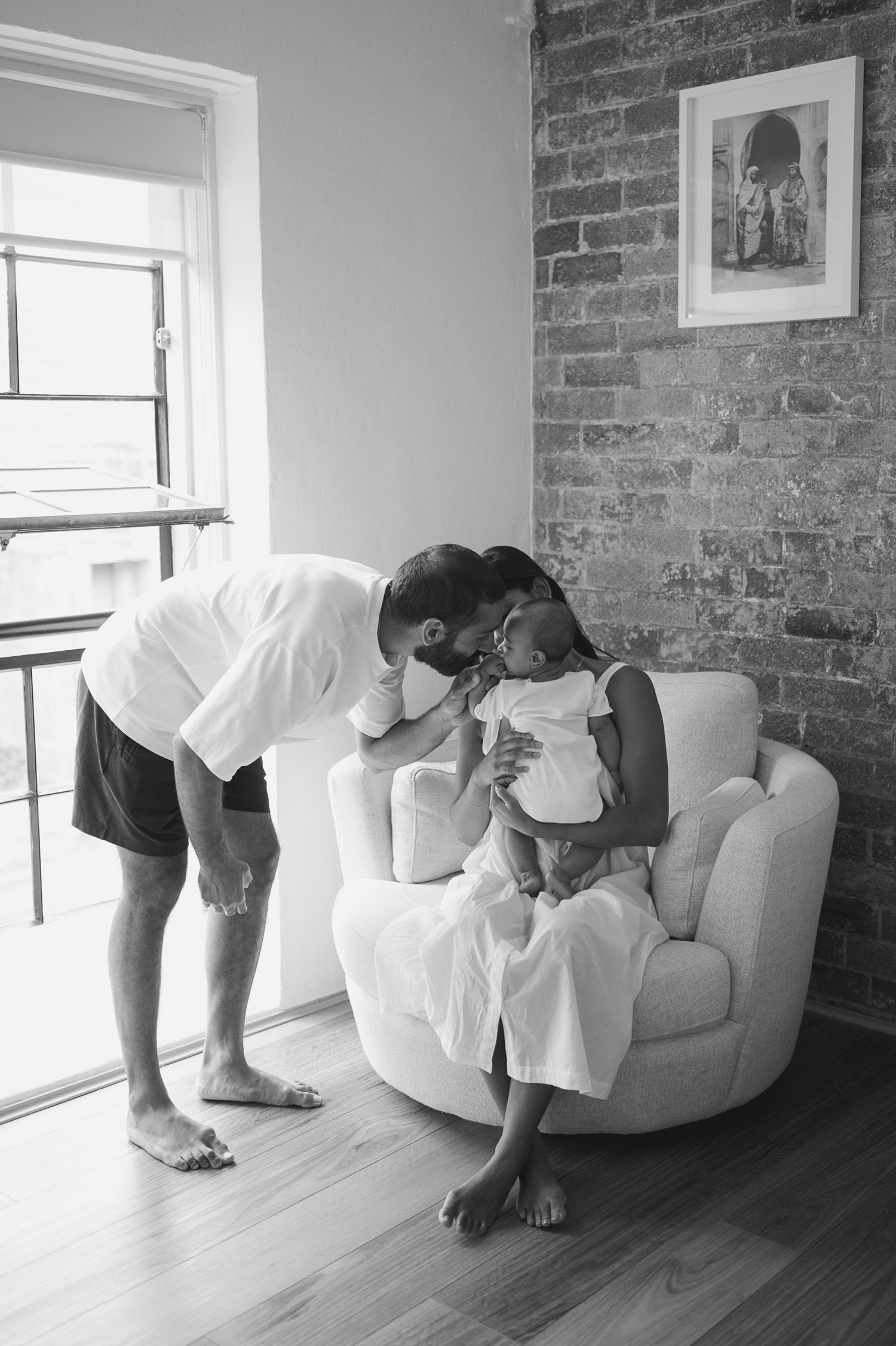 Family portraits indoors in black and white.